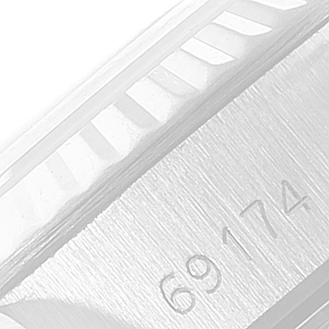The image shows a close-up of the bezel and part of the case with the model number of a Rolex Datejust 69174 Women
s Stainless Steel Silver Dial 69174 Women
s Stainless Steel Silver Dial watch.