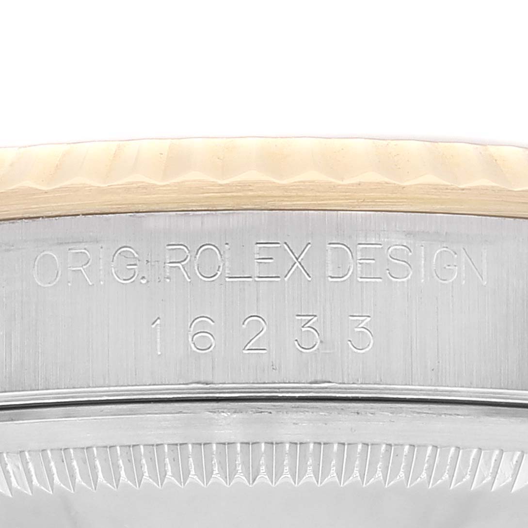 This image shows a close-up of the case side of a Rolex Datejust 16233 Men's Steel and Gold (two tone) Black Dial 16233 Men's Steel and Gold (two tone) Black Dial; the model number and design engraving are visible.