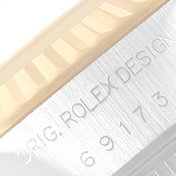 This close-up image shows the fluted bezel and engraved case side of a Rolex Datejust 69173 Women
s Steel and Gold (two tone) Champagne Dial 69173 Women
s Steel and Gold (two tone) Champagne Dial watch.