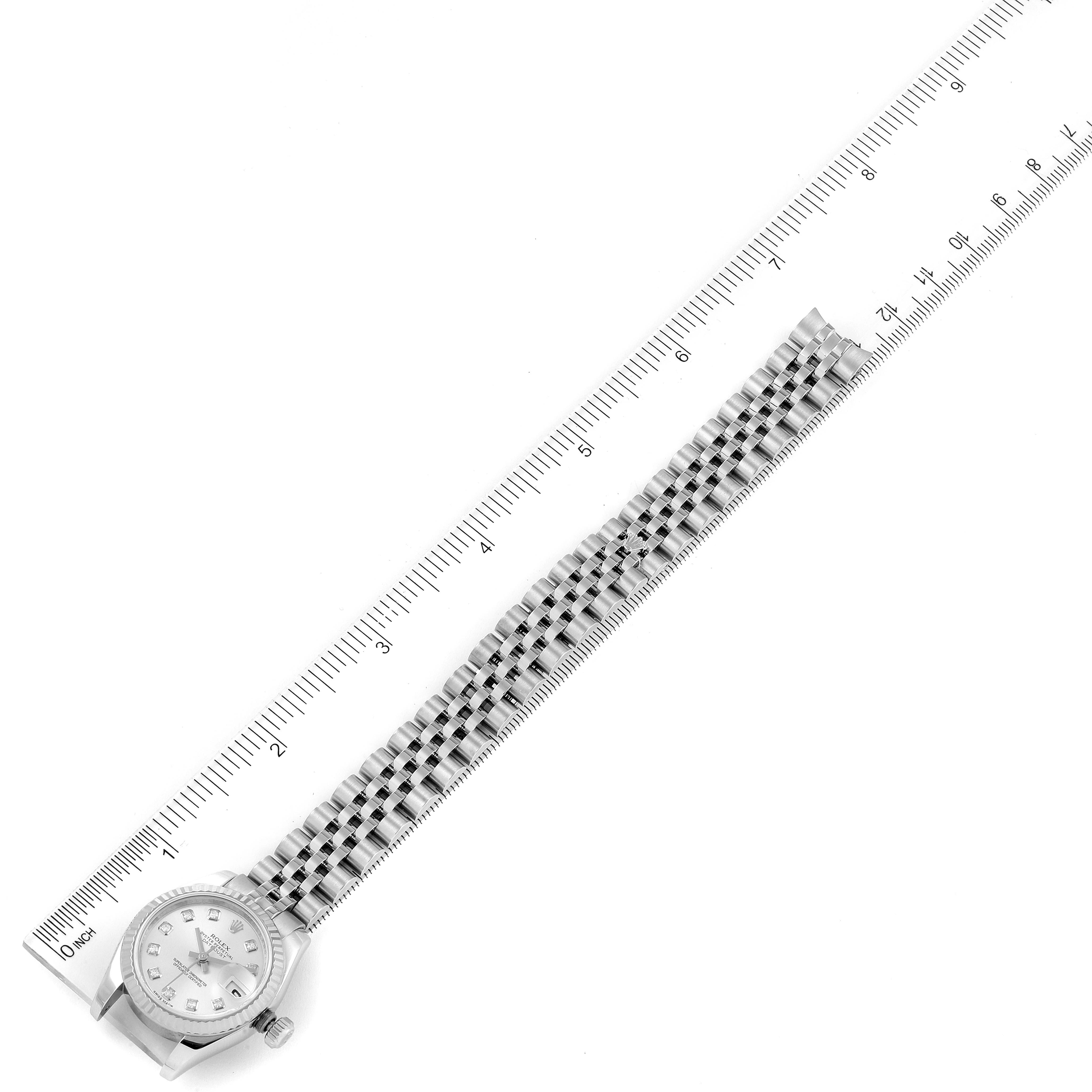 The image shows a Rolex Datejust 179174 Women's Stainless Steel Silver Dial 179174 Women's Stainless Steel Silver Dial watch positioned alongside a ruler, displaying the watch face and bracelet at an overhead angle.