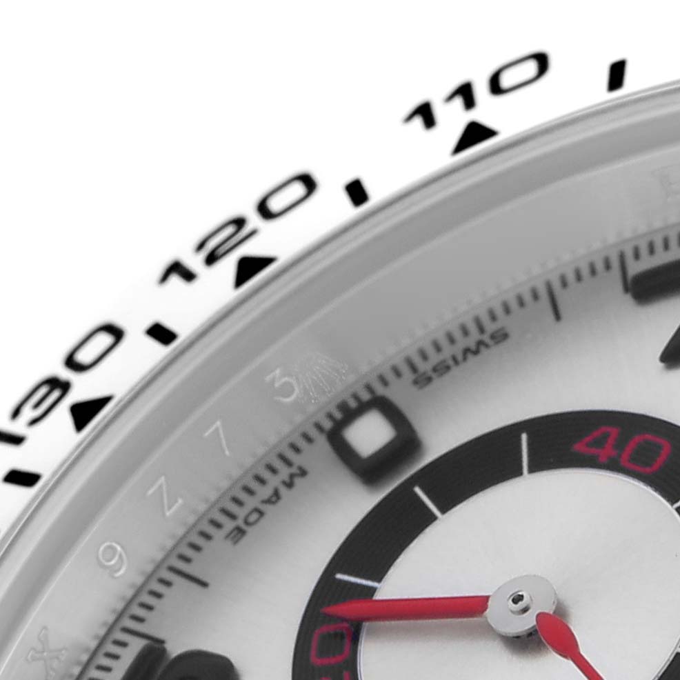 The image shows a close-up of the Rolex Daytona 116509 Men
s White Gold Silver Dial 116509 Men
s White Gold Silver Dial
s bezel and part of its dial, highlighting the tachymetric scale and red second hand.
