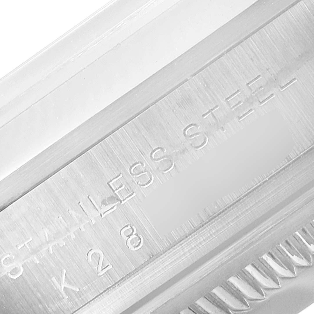 This close-up image shows the stainless steel inscription on a Rolex Explorer 114270 Men
s Stainless Steel Black Dial 114270 Men
s Stainless Steel Black Dial model
s case or watch band.