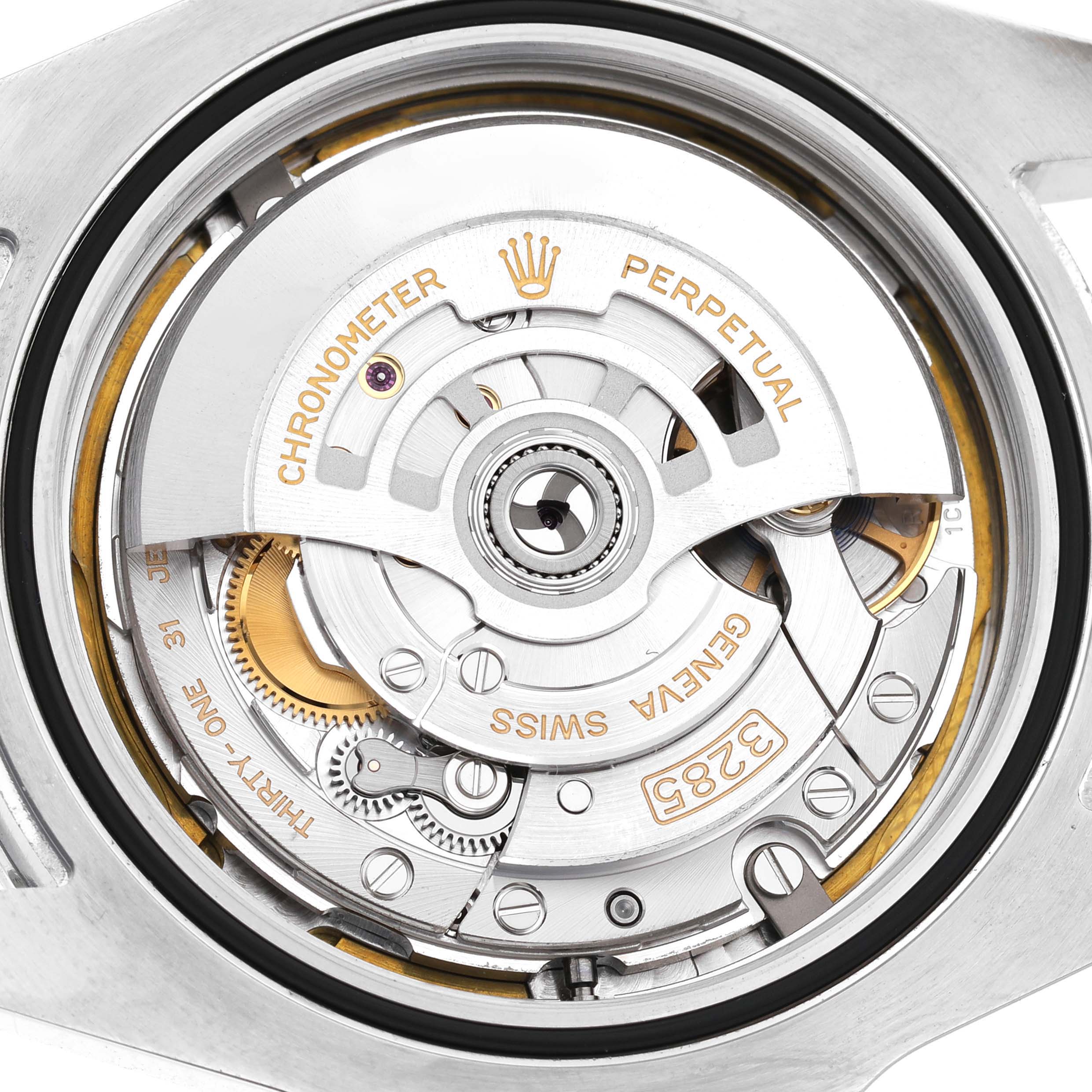 The image shows the movement of a Rolex Explorer 226570 Men's Stainless Steel White Dial, highlighting its intricate mechanical components from a top-down angle.