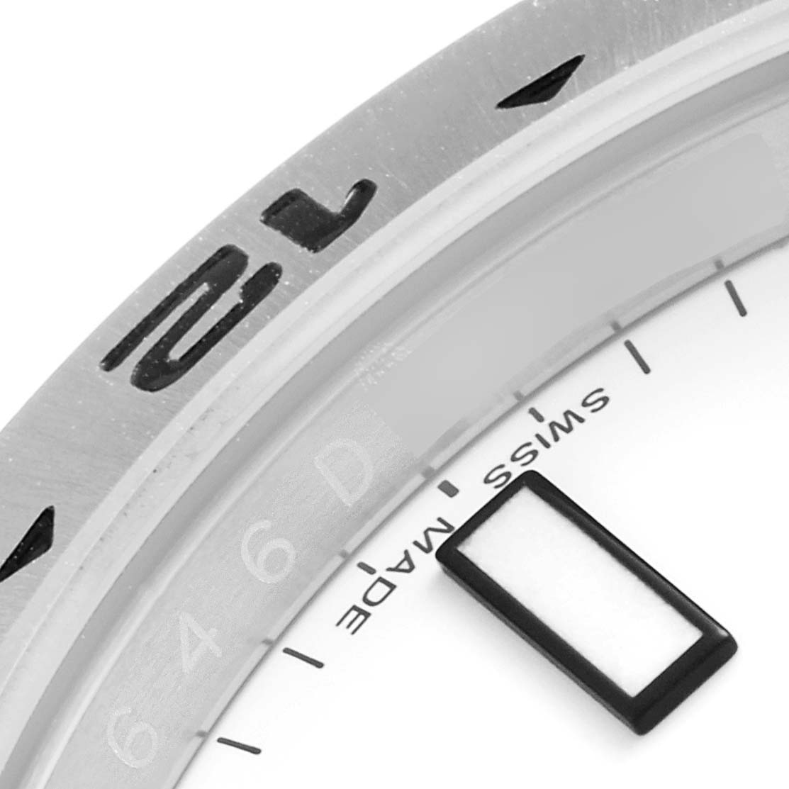 The image shows a close-up of the bezel and part of the dial of a Rolex Explorer 216570 Men
s Stainless Steel White Dial 216570 Men
s Stainless Steel White Dial watch.