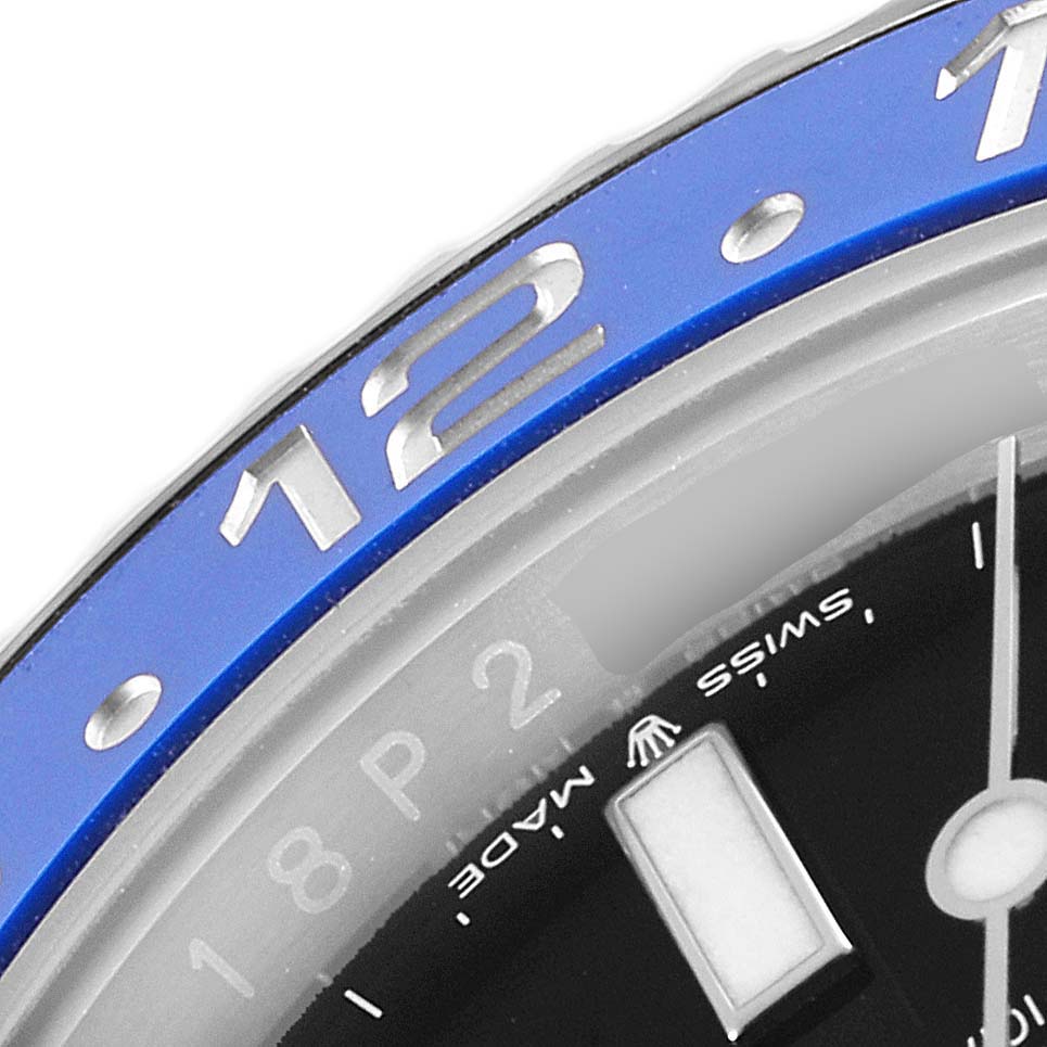 The image shows a close-up of the bezel and part of the dial of a Rolex GMT-Master 126710 Men
s Stainless Steel Black Dial 126710 Men
s Stainless Steel Black Dial watch, highlighting the "12" marker.