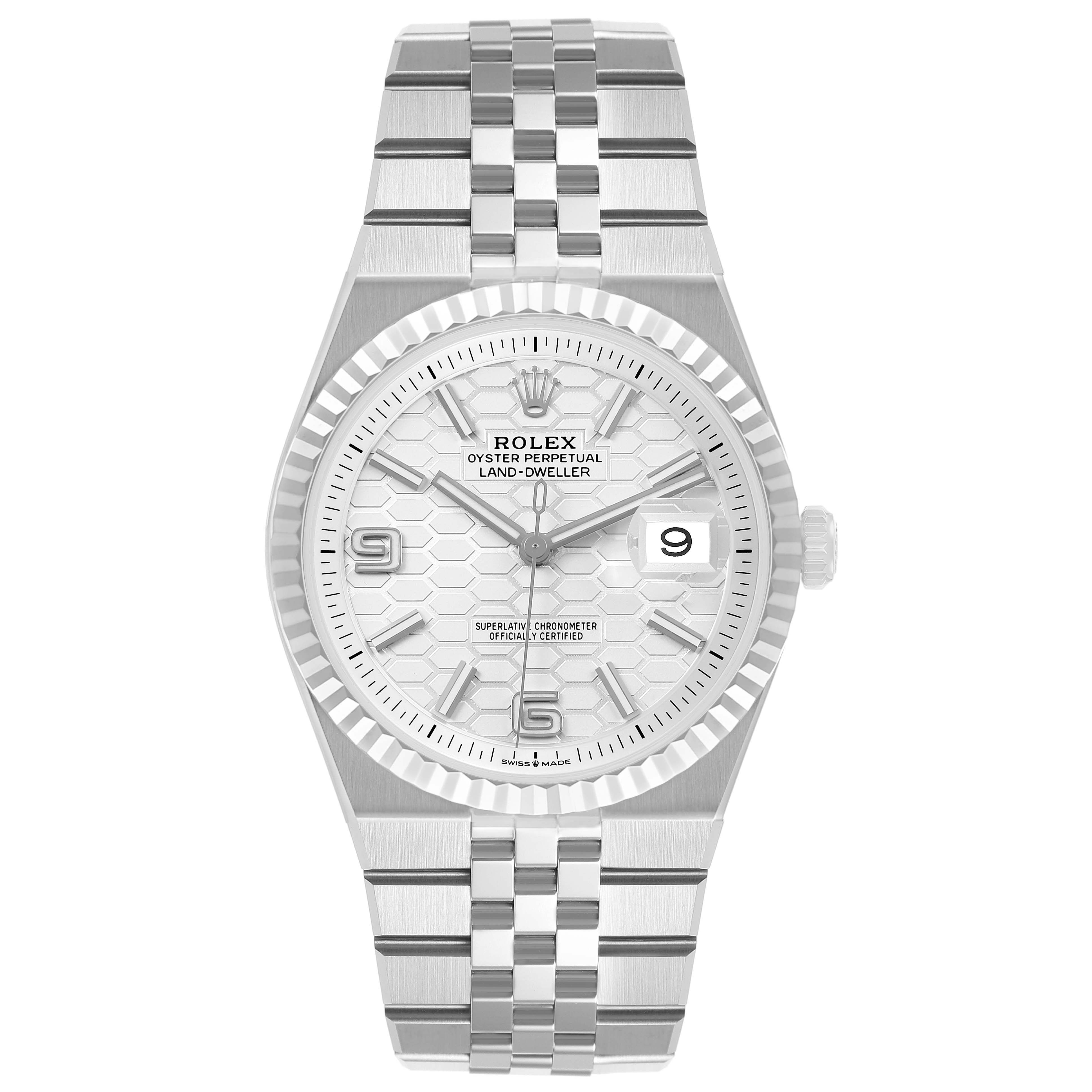 The Rolex Land-Dweller watch is shown from the front, displaying its face, bezel, and bracelet clearly.