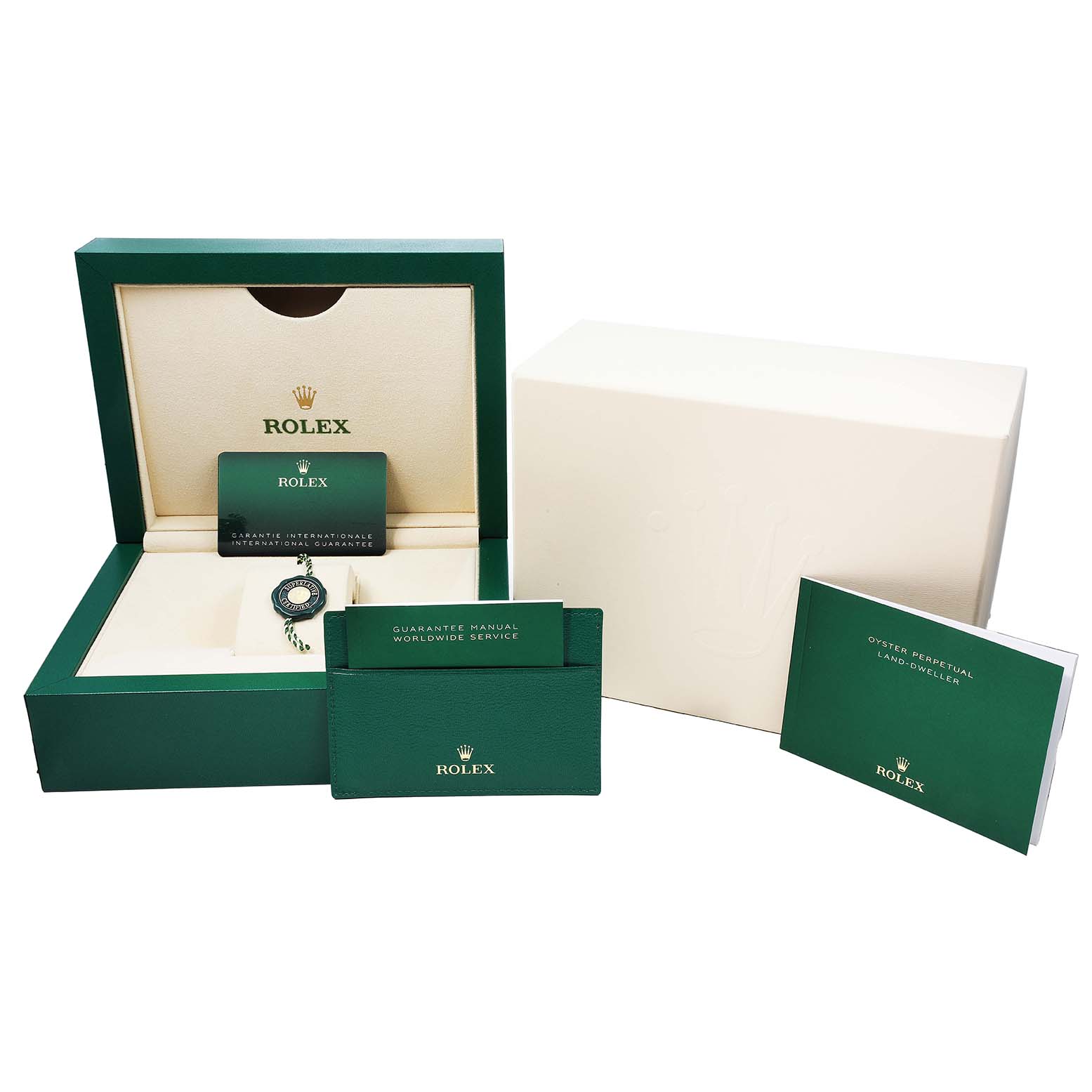 The image shows a Rolex Land-Dweller watch box, warranty card, manuals, and accessory tag at a front angle.