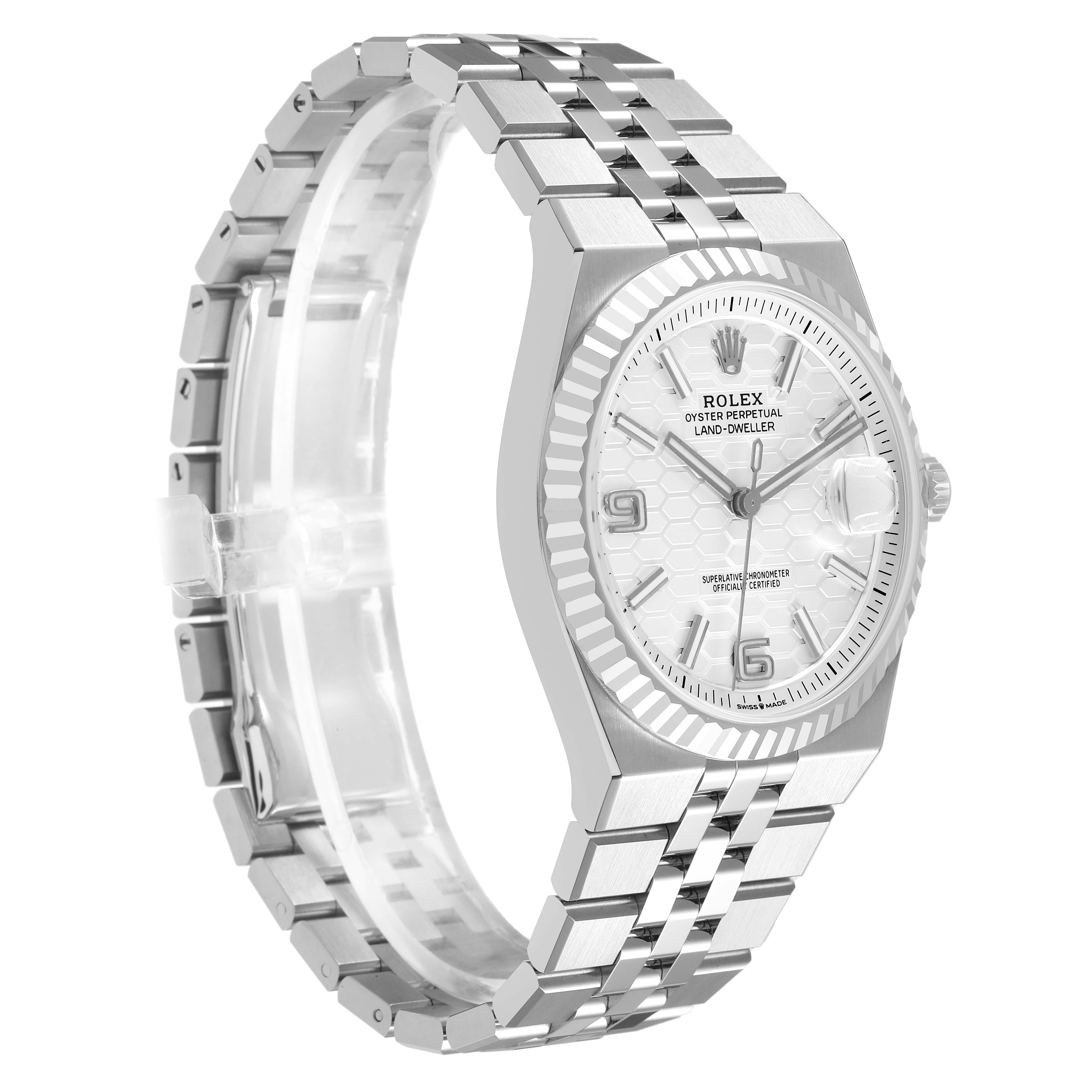 The Rolex Land-Dweller watch is shown at a three-quarter angle, highlighting the face, bezel, and bracelet.