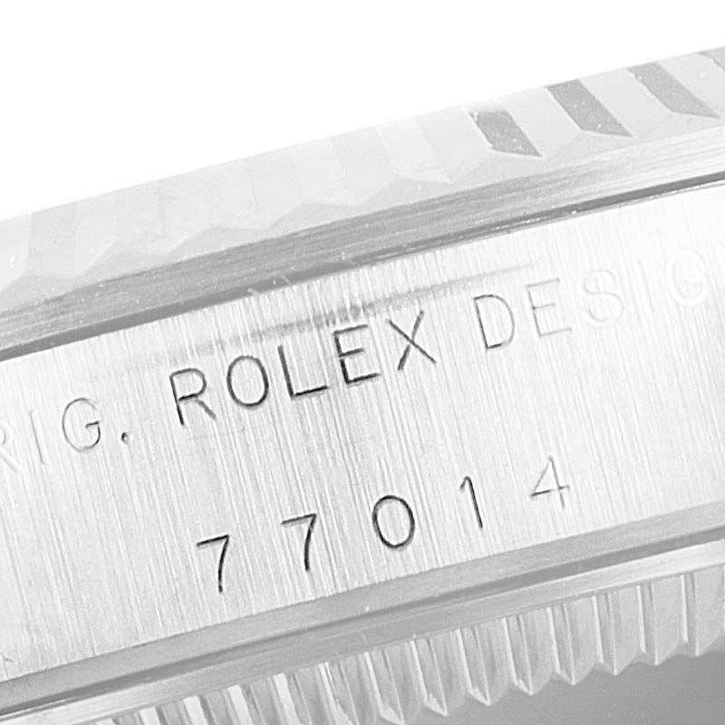 The image shows the side engraving on the bezel of a Mid-Size Rolex watch.