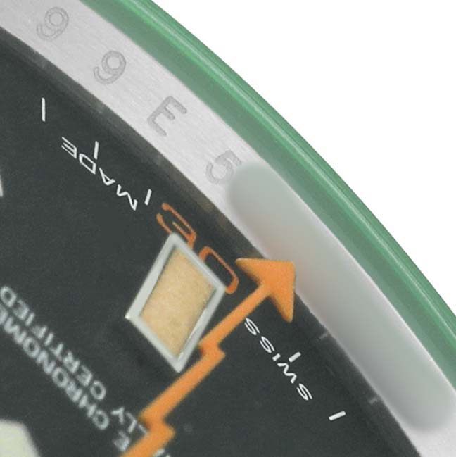 The image shows a close-up of the dial and bezel of a Rolex Milgauss 116400GV Men's Stainless Steel Black Dial, focusing on the orange lightning bolt second hand and part of the chapter ring.