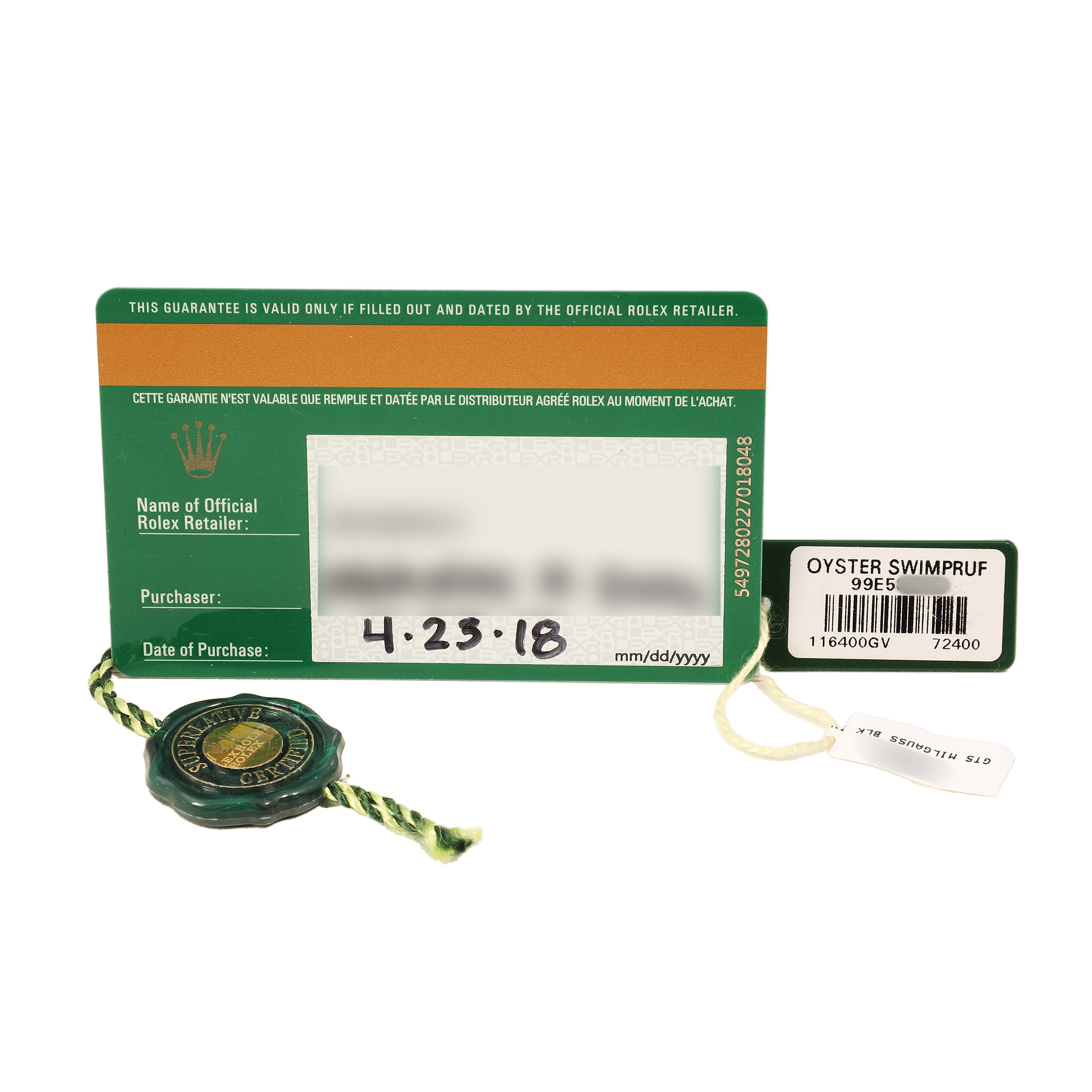 The image shows a Rolex Milgauss 116400GV Men's Stainless Steel Black Dial warranty card, green tag, and Swimpruf tag, viewed from above.