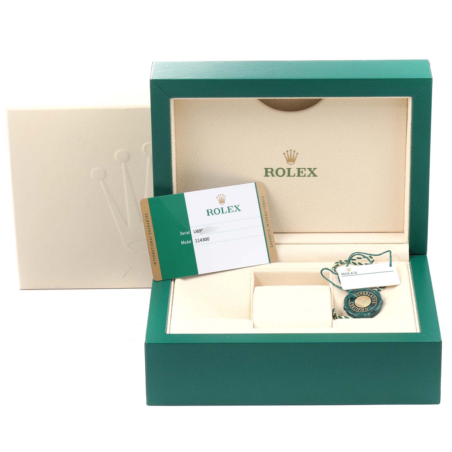 The image shows the box, warranty card, and hang tag for a Rolex Oyster Perpetual 114300 Men
s Stainless Steel Blue Dial 114300 Men
s Stainless Steel Blue Dial watch, model 114300.