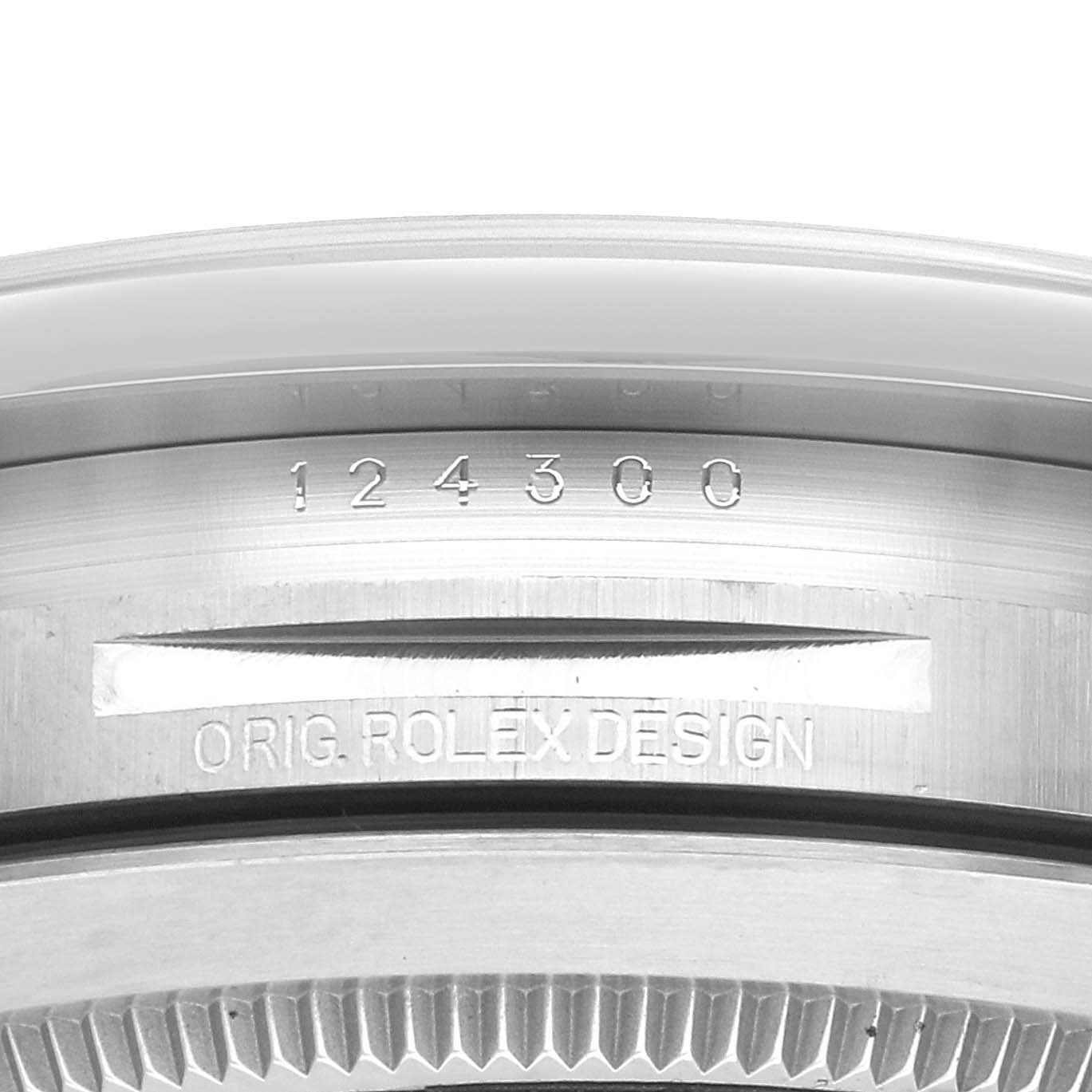 The image shows a close-up of the side of the Rolex Oyster Perpetual 124300 Men
s Stainless Steel Blue Dial 124300 Men
s Stainless Steel Blue Dial, highlighting the model number and "ORIG. ROLEX DESIGN" engraving.