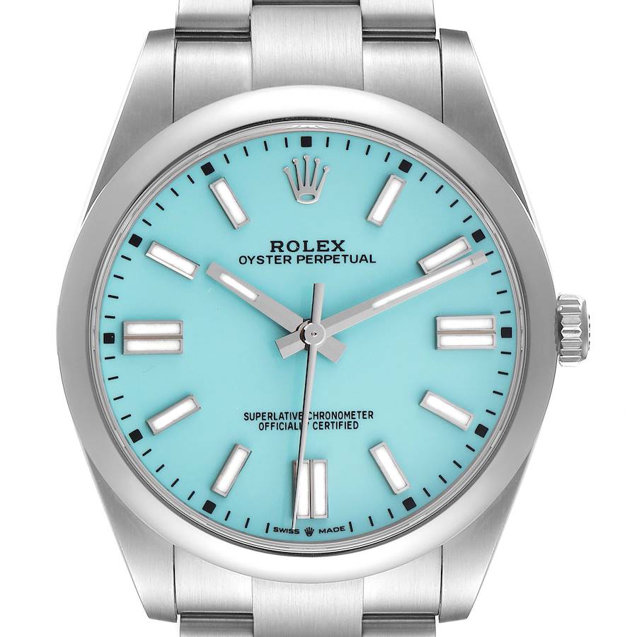 The Rolex Oyster Perpetual watch is shown from a front view, displaying its turquoise dial, markers, and bezel clearly.
