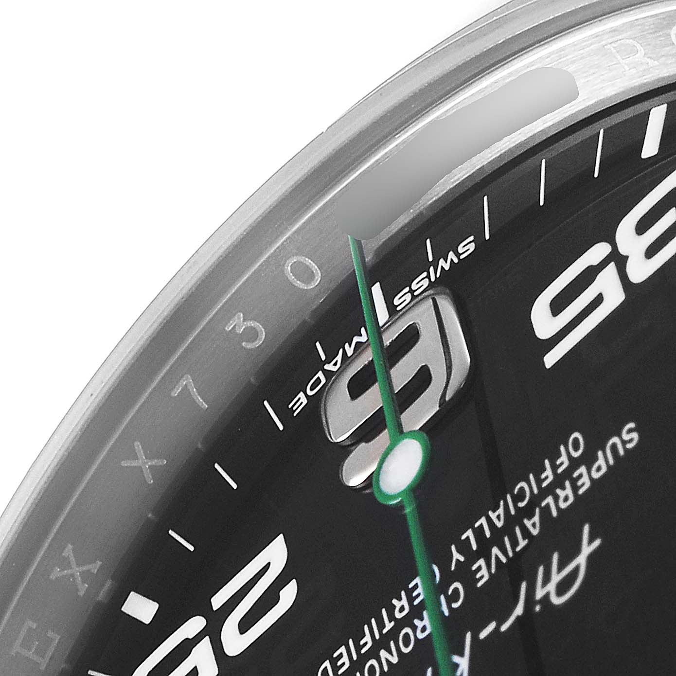 This close-up image of the Rolex Air-King 116900 Men's Stainless Steel Black Dial 116900 Men's Stainless Steel Black Dial watch shows part of the dial, including the '9' marker, minute markers, and the green second hand.