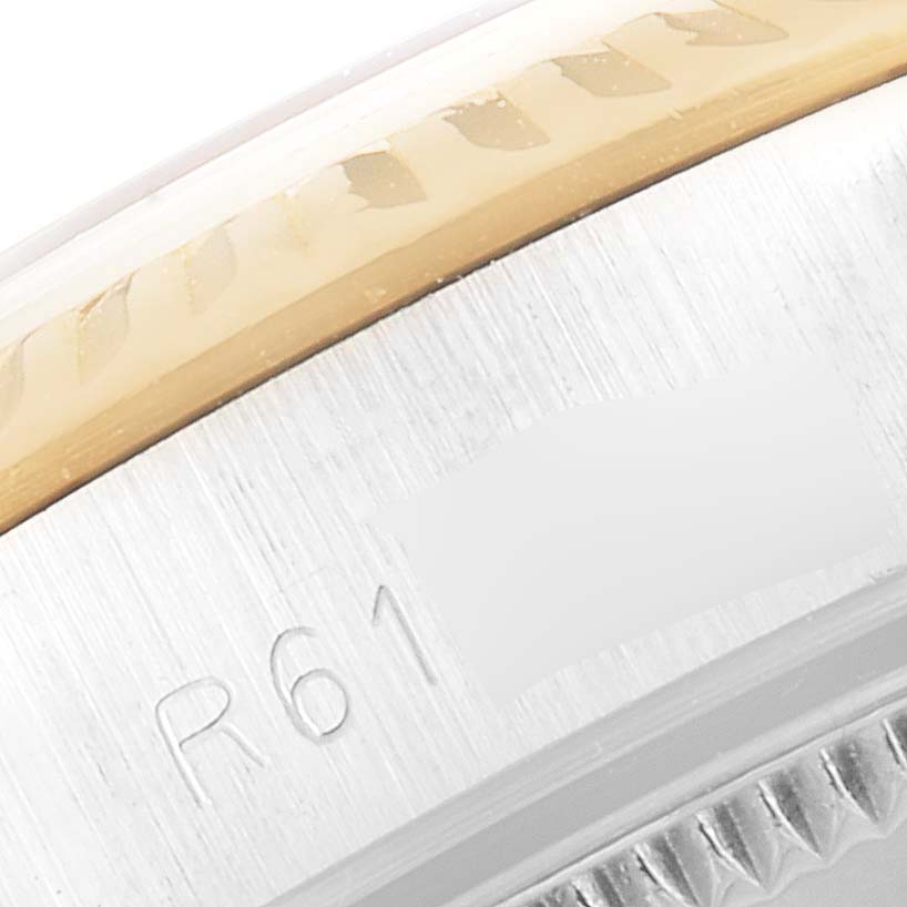 This close-up image shows the side of the bezel and part of the case of a Rolex Oyster Perpetual 67193 Women
s Steel and Gold (two tone) Champagne Dial 67193 Women
s Steel and Gold (two tone) Champagne Dial watch, displaying the model engraving.