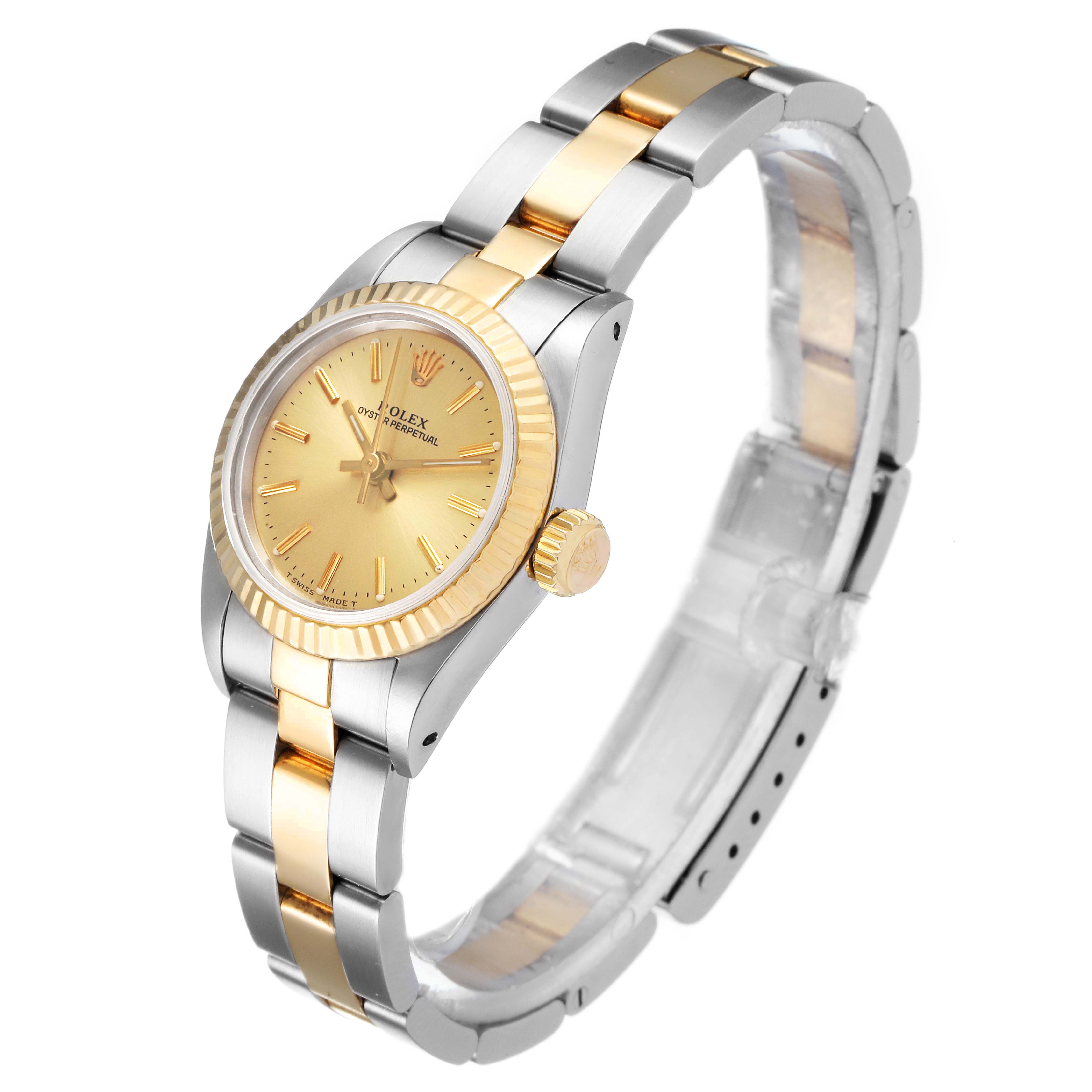 This image shows a front-left angle of a Rolex Oyster Perpetual 67193 Women
s Steel and Gold (two tone) Champagne Dial 67193 Women
s Steel and Gold (two tone) Champagne Dial watch, highlighting its two-tone bracelet and fluted bezel.