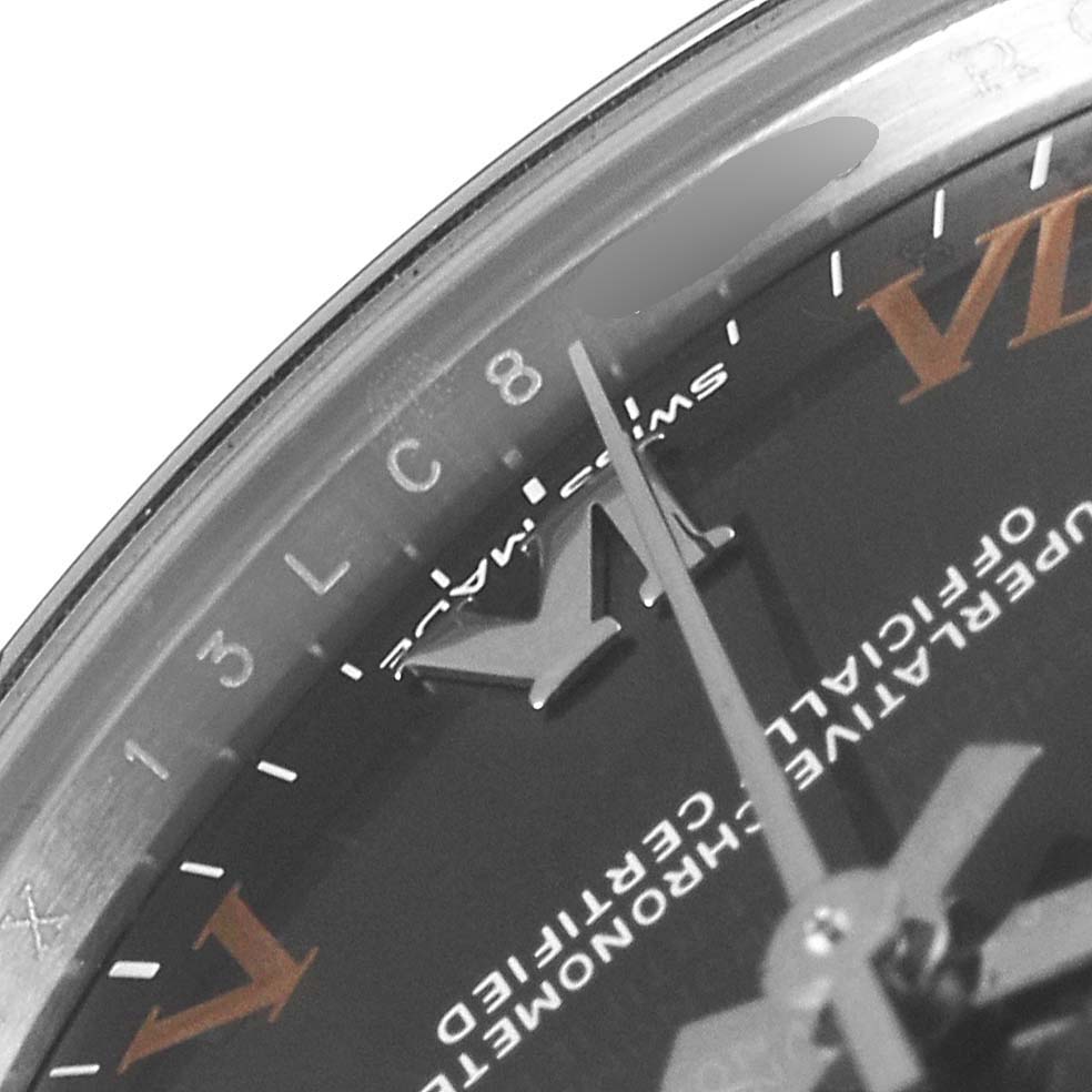 The image shows a close-up of the dial and hands of a Mid-Size Rolex, highlighting the Roman numerals and text.