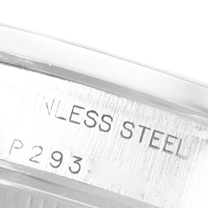 This close-up image shows the side engraving of a Rolex Oyster Perpetual 76080 Women's Stainless Steel Silver Dial 76080 Women's Stainless Steel Silver Dial watch, indicating it is made from stainless steel with partial serial numbers.