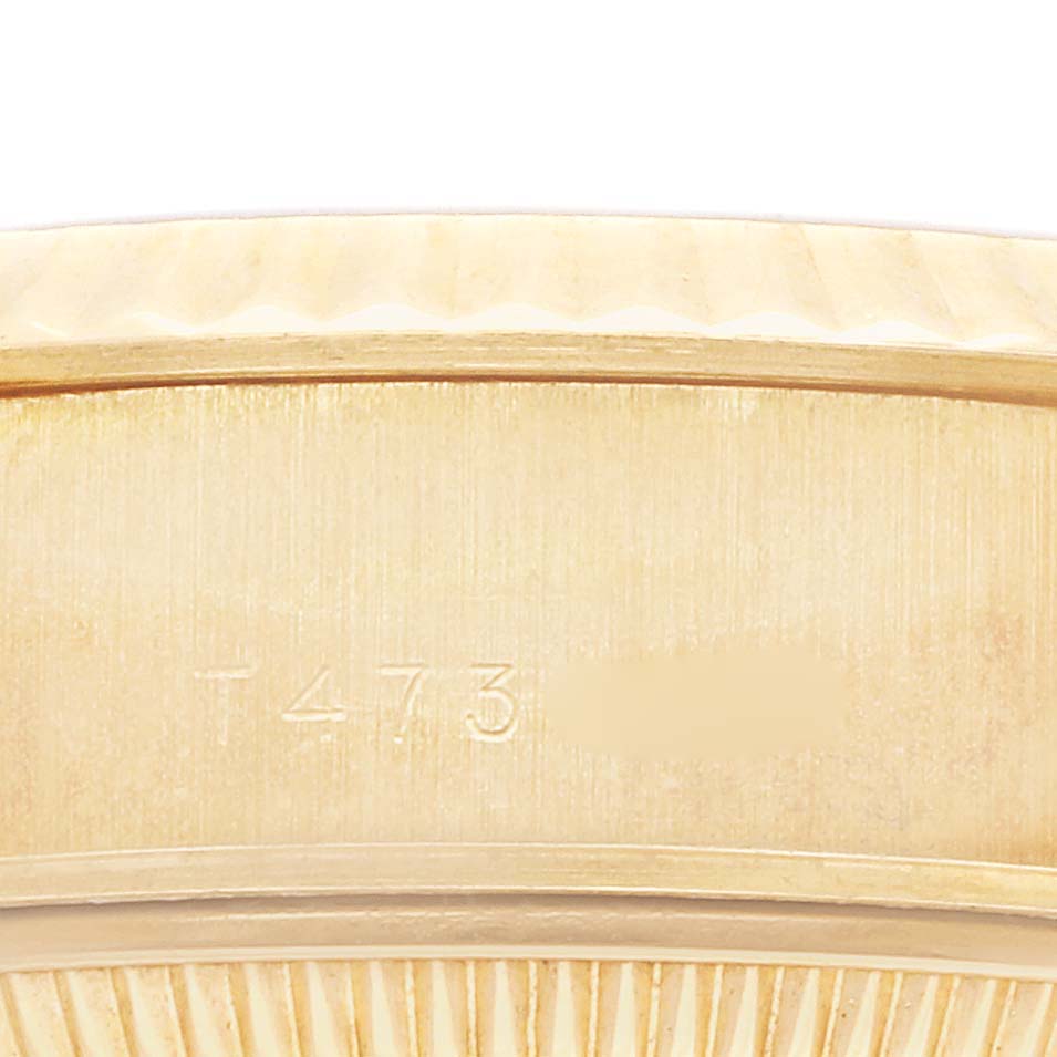 The image shows a close-up of the Rolex President 69178 Women's Yellow Gold Champagne Dial 69178 Women's Yellow Gold Champagne Dial model's band, highlighting engraved details and texture.