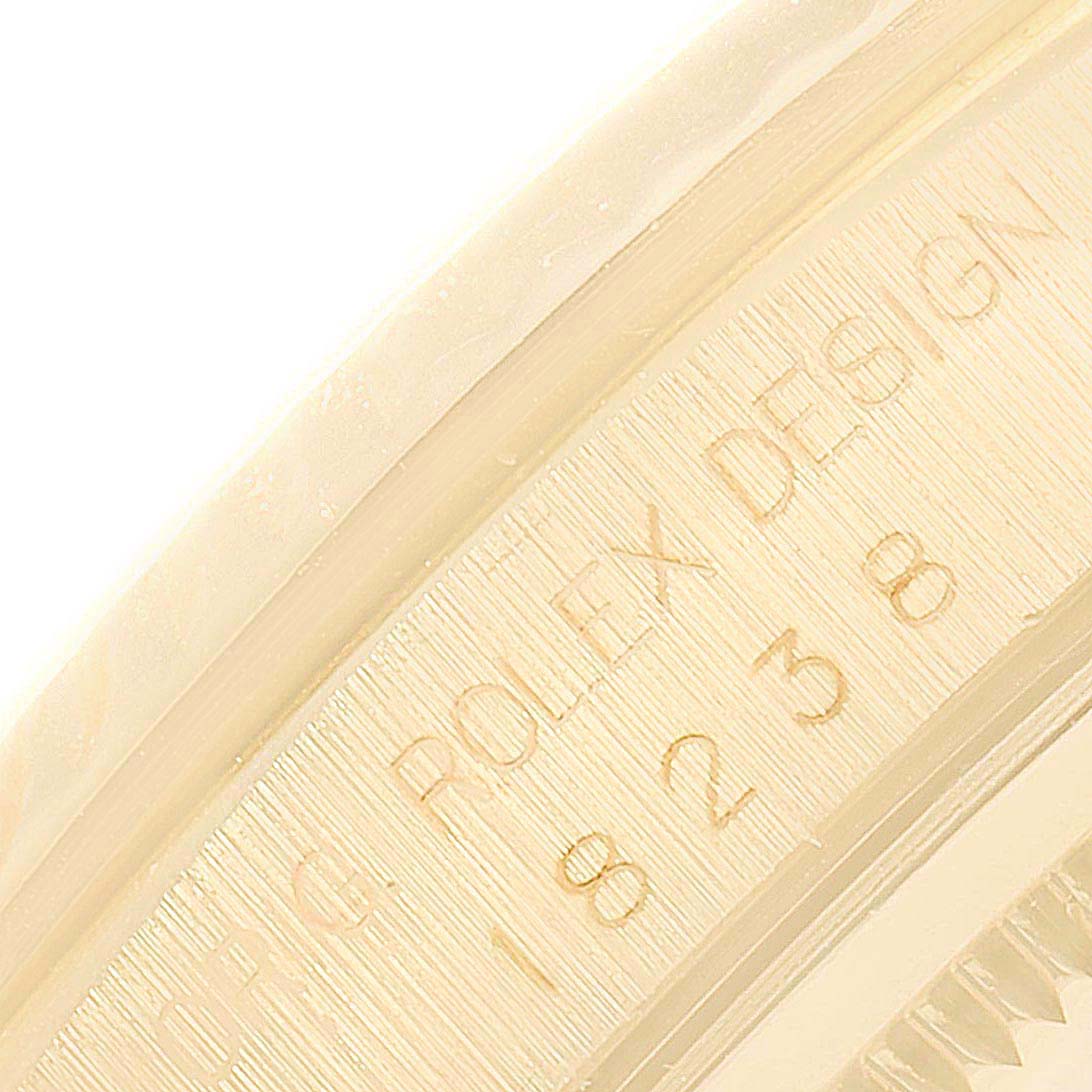The image shows a close-up of the engraved "ORIG ROLEX DESIGN" and model number on the case of the Rolex President 18238 Men's Yellow Gold Champagne Dial 18238 Men's Yellow Gold Champagne Dial watch.