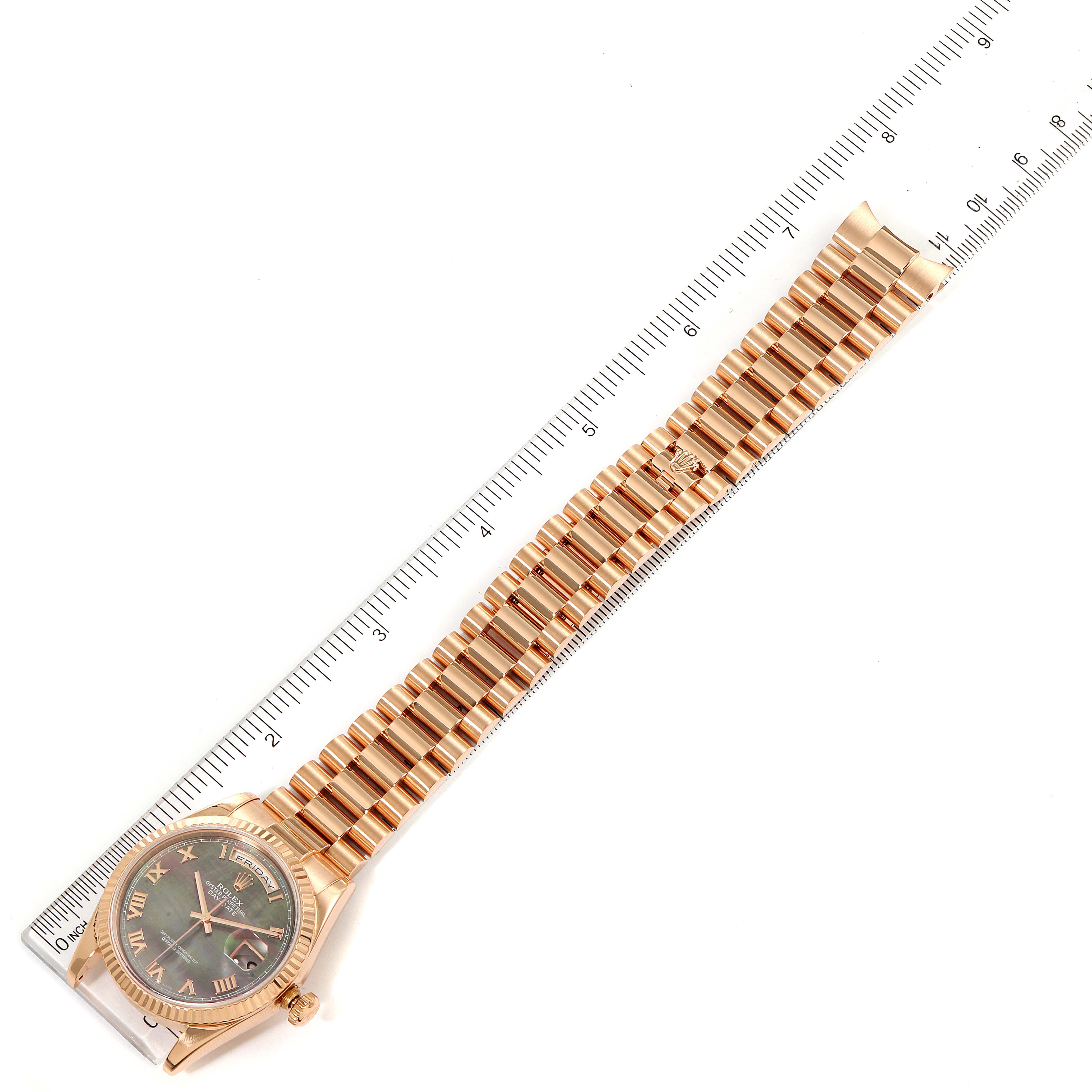 The image shows a Rolex President 118235 Men's Rose Gold Mother of Pearl Dial 118235 Men's Rose Gold Mother of Pearl Dial model watch laid flat next to a ruler, displaying the full bracelet and face.
