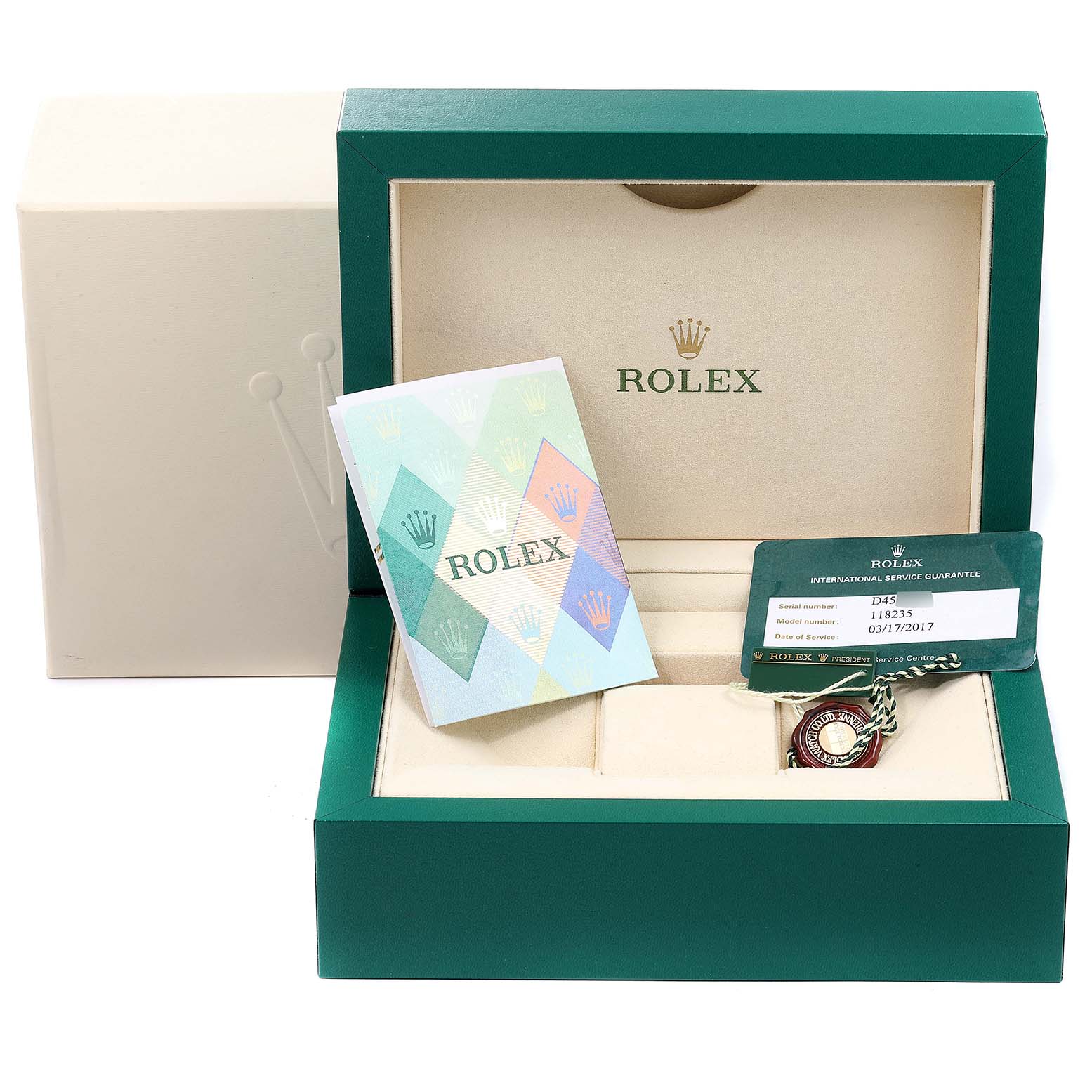 The image shows the packaging, an international service guarantee card, and an accessory for the President model by Rolex.