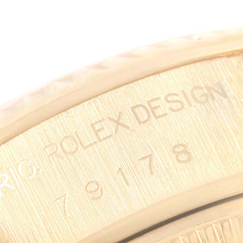 The image shows a close-up of the case back edge of a Rolex President 79178 Women
s Yellow Gold Mother of Pearl Dial 79178 Women
s Yellow Gold Mother of Pearl Dial model watch, highlighting the engraved "ROLEX DESIGN" and a serial number.