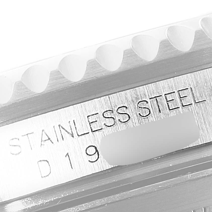 This close-up image shows the side engraving of a Rolex Submariner 16610LV Men
s Stainless Steel Black Dial 16610LV Men
s Stainless Steel Black Dial model, indicating "STAINLESS STEEL" and a partial serial number.