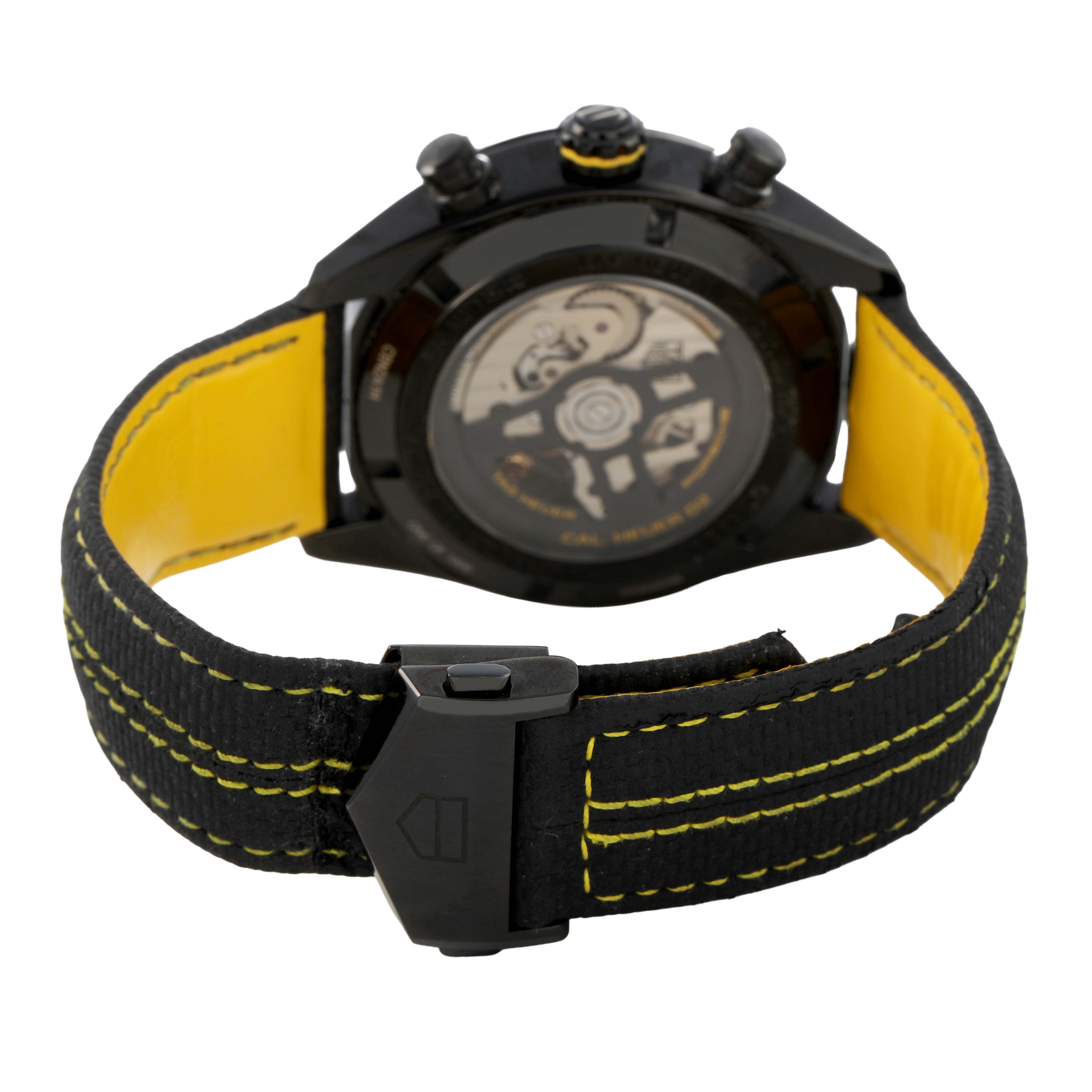 The image shows the back of a Tag Heuer Carrera CBN2A1H Men's Stainless Steel Black Dial watch, highlighting the case back, strap, and deployment clasp.