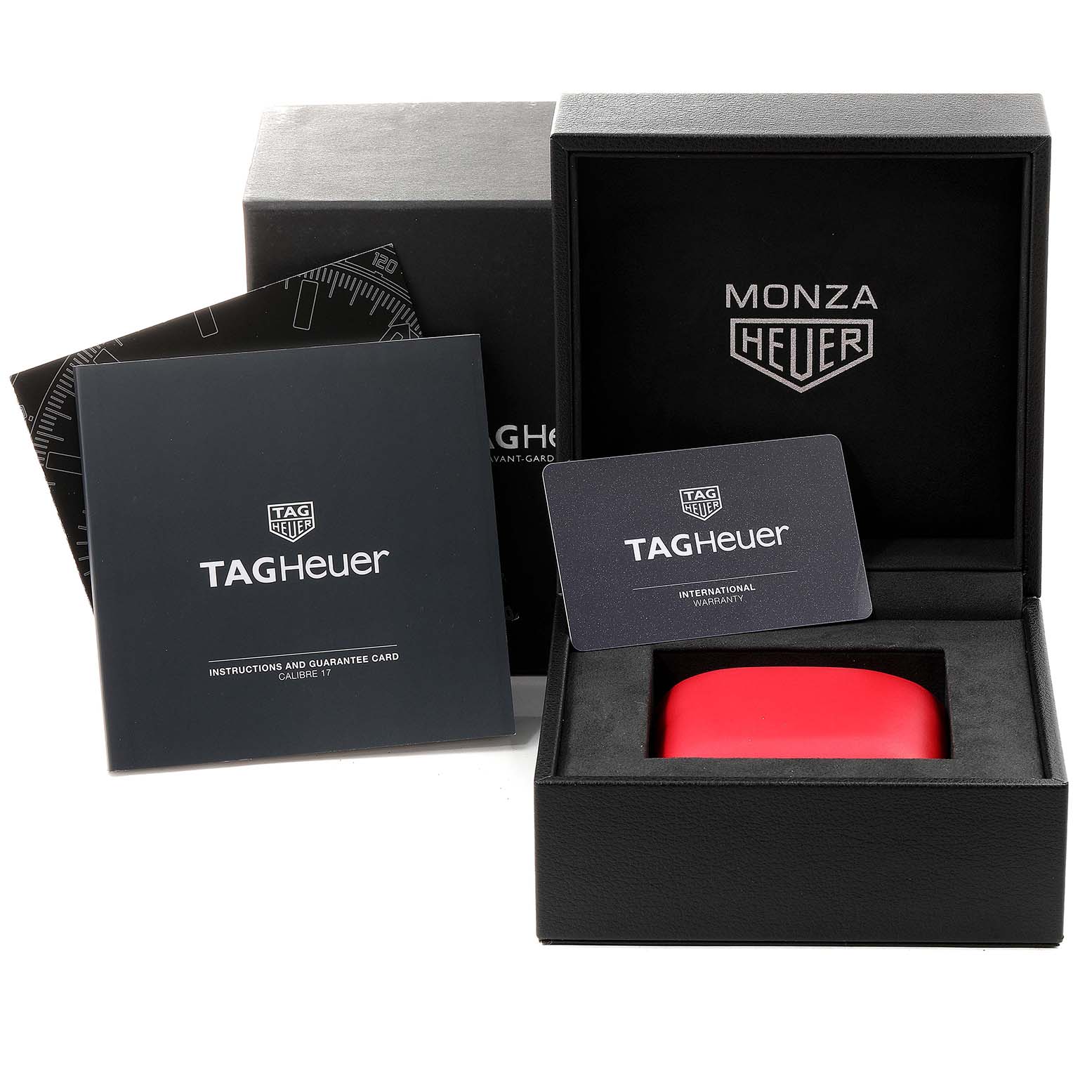 This image shows the packaging, warranty card, and instruction booklet for the Tag Heuer Monza watch.