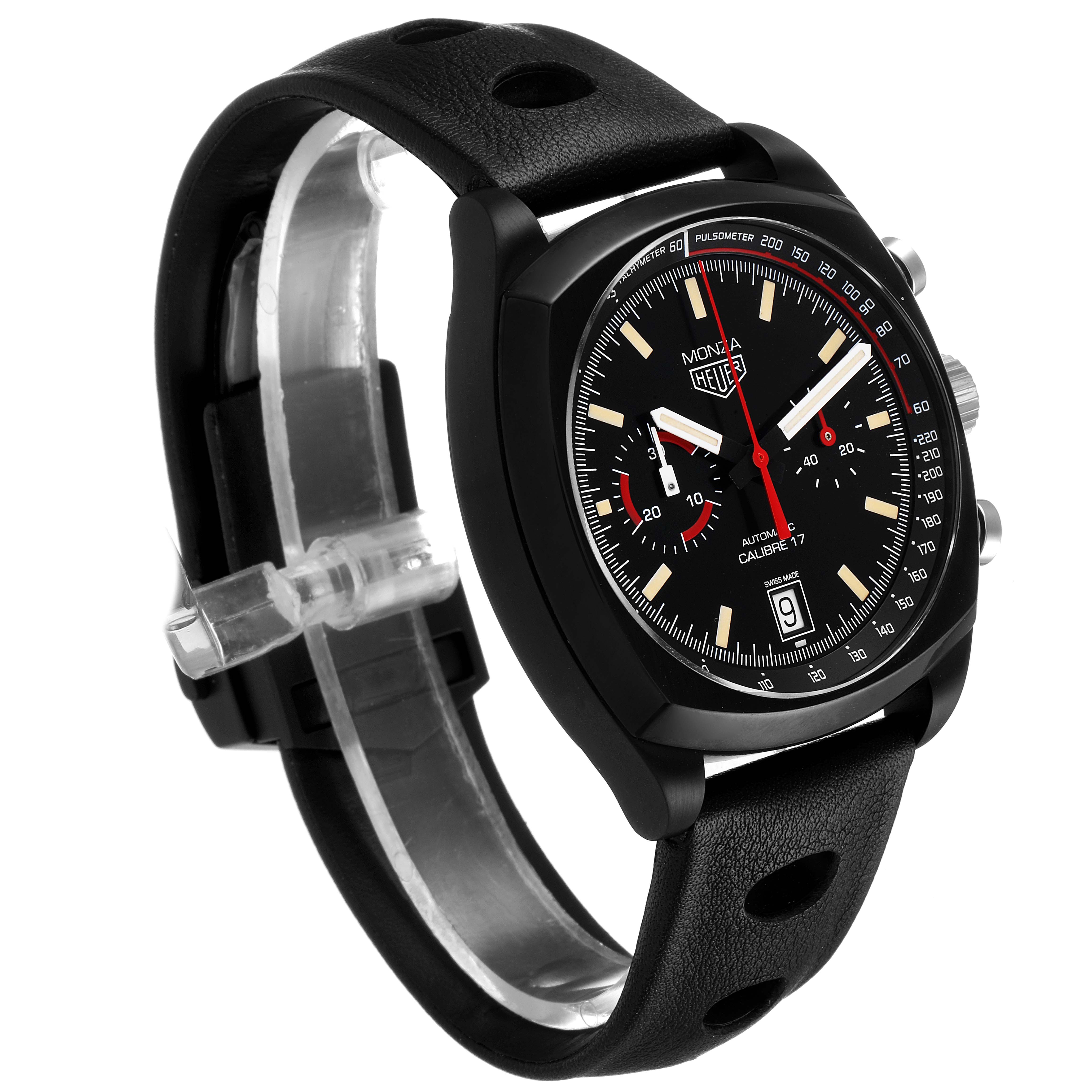 The image shows a Tag Heuer Monza watch at a slight angle, highlighting its black dial, chronograph functions, and perforated black leather strap.