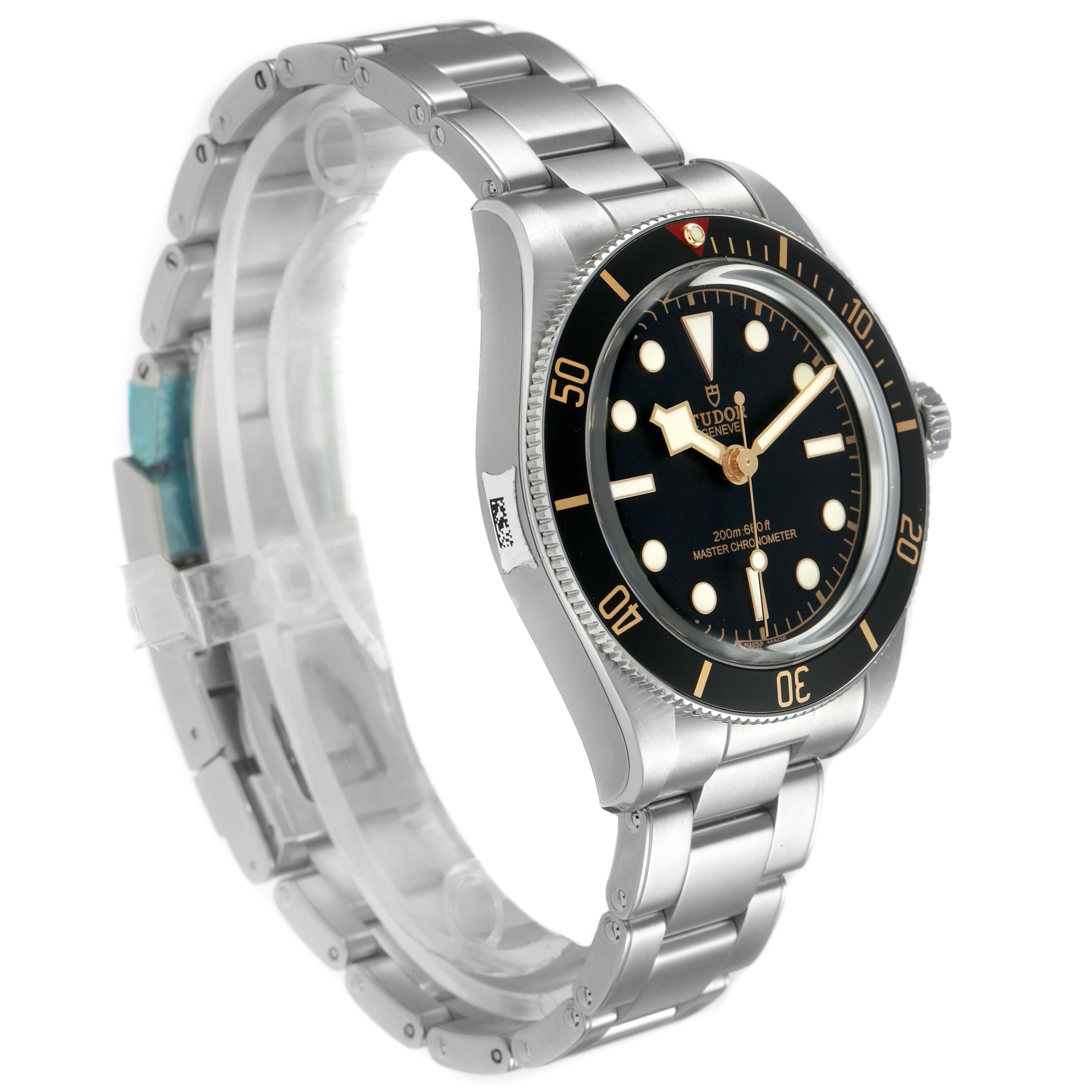 The Tudor Heritage Black Bay 7939A1A0NU Men's Stainless Steel Black Dial watch is shown at a three-quarter angle, displaying the dial, bezel, and bracelet.