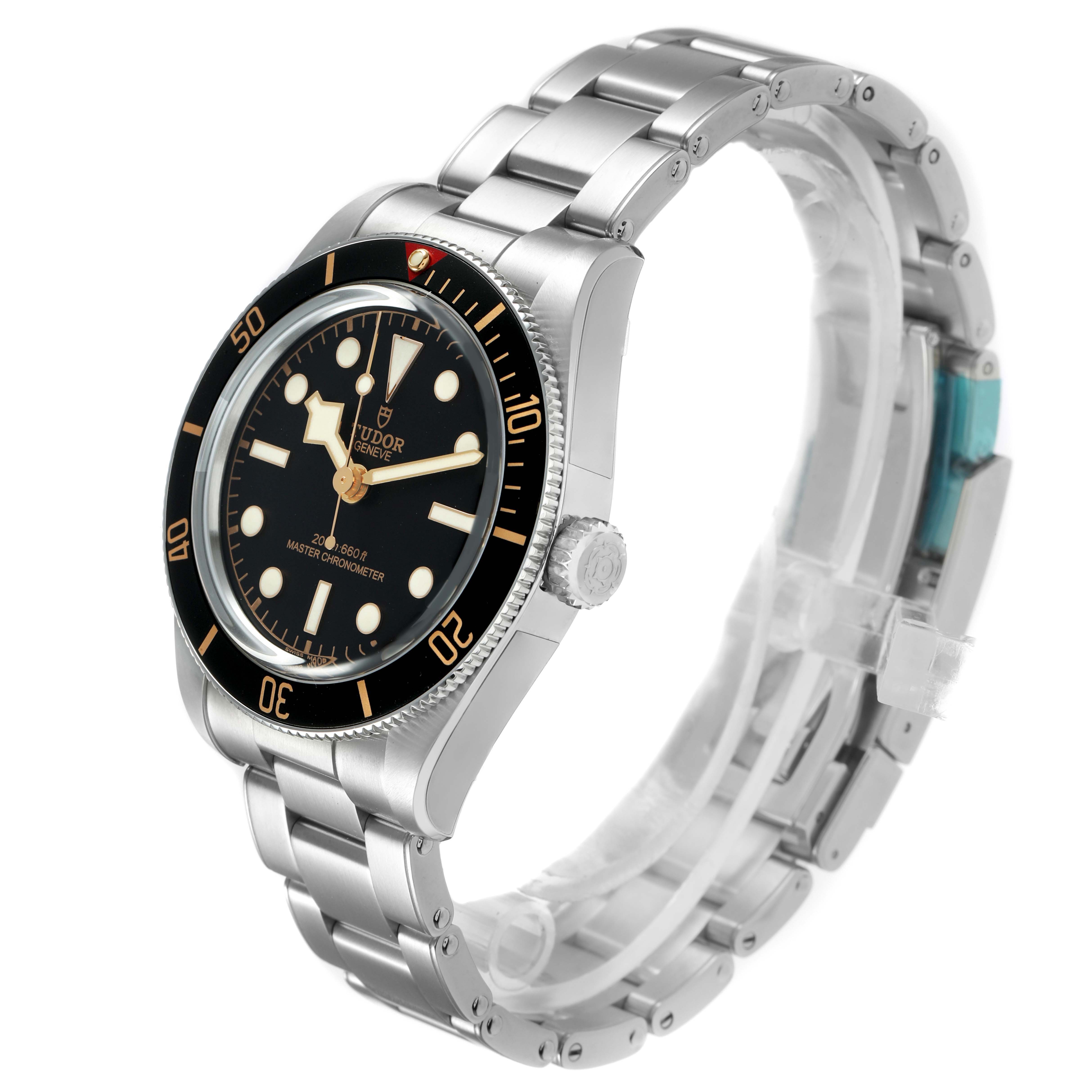 The Tudor Heritage Black Bay 7939A1A0NU Men's Stainless Steel Black Dial watch is shown at a three-quarter angle, highlighting the bezel, dial, crown, and bracelet.