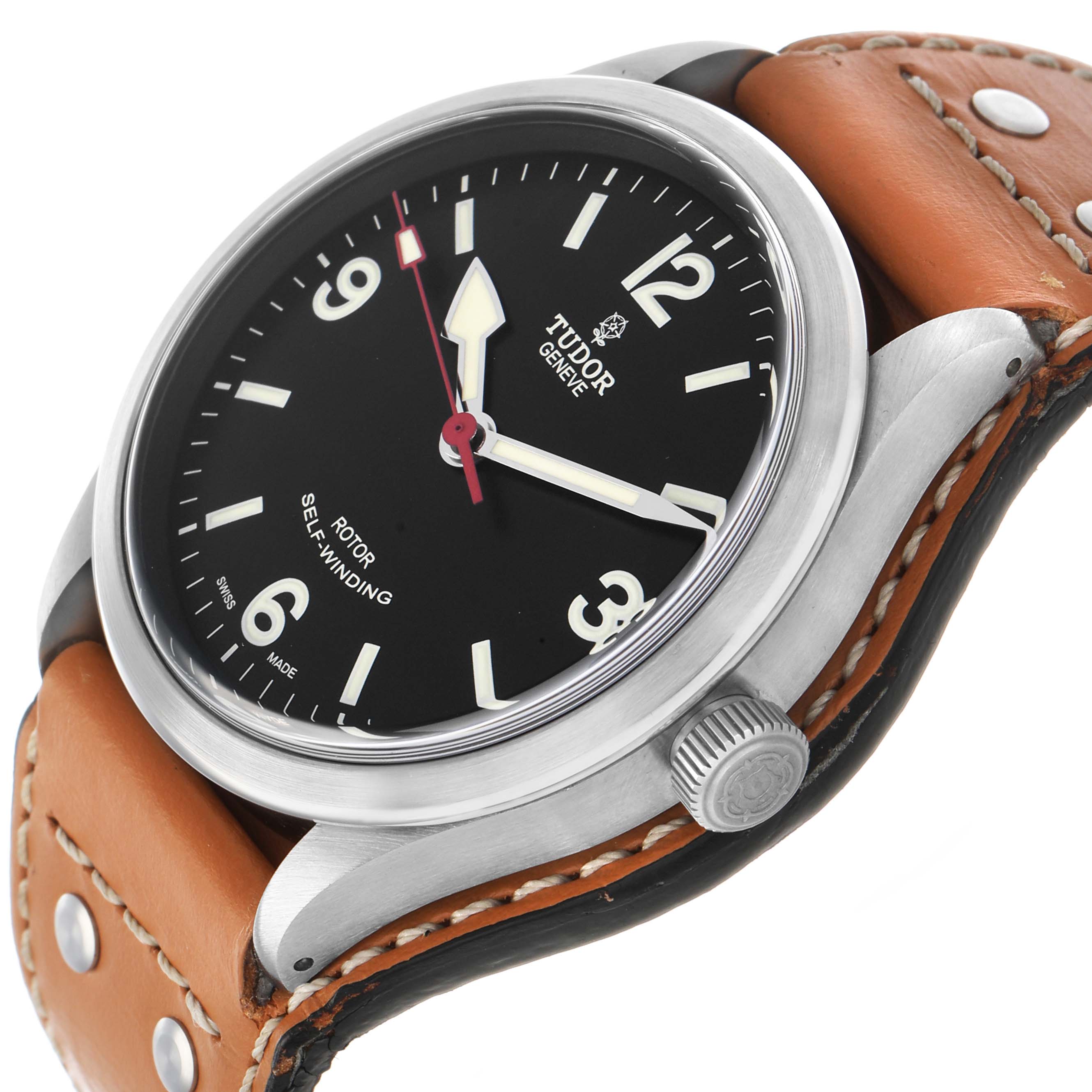 The Tudor Heritage Ranger M79910-0002 Men's Stainless Steel Black Dial watch is shown at an angled close-up, highlighting the dial, case, and crown with a brown leather strap.