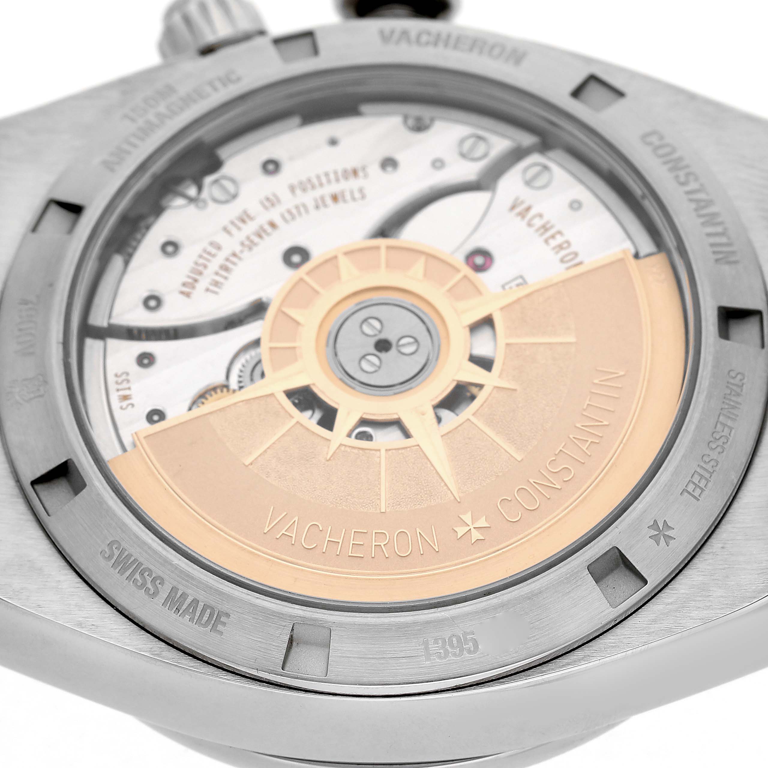 The image shows the Vacheron Constantin Overseas 7900V Men's Stainless Steel Silver Dial model from the back, highlighting the intricate movement and rotor.