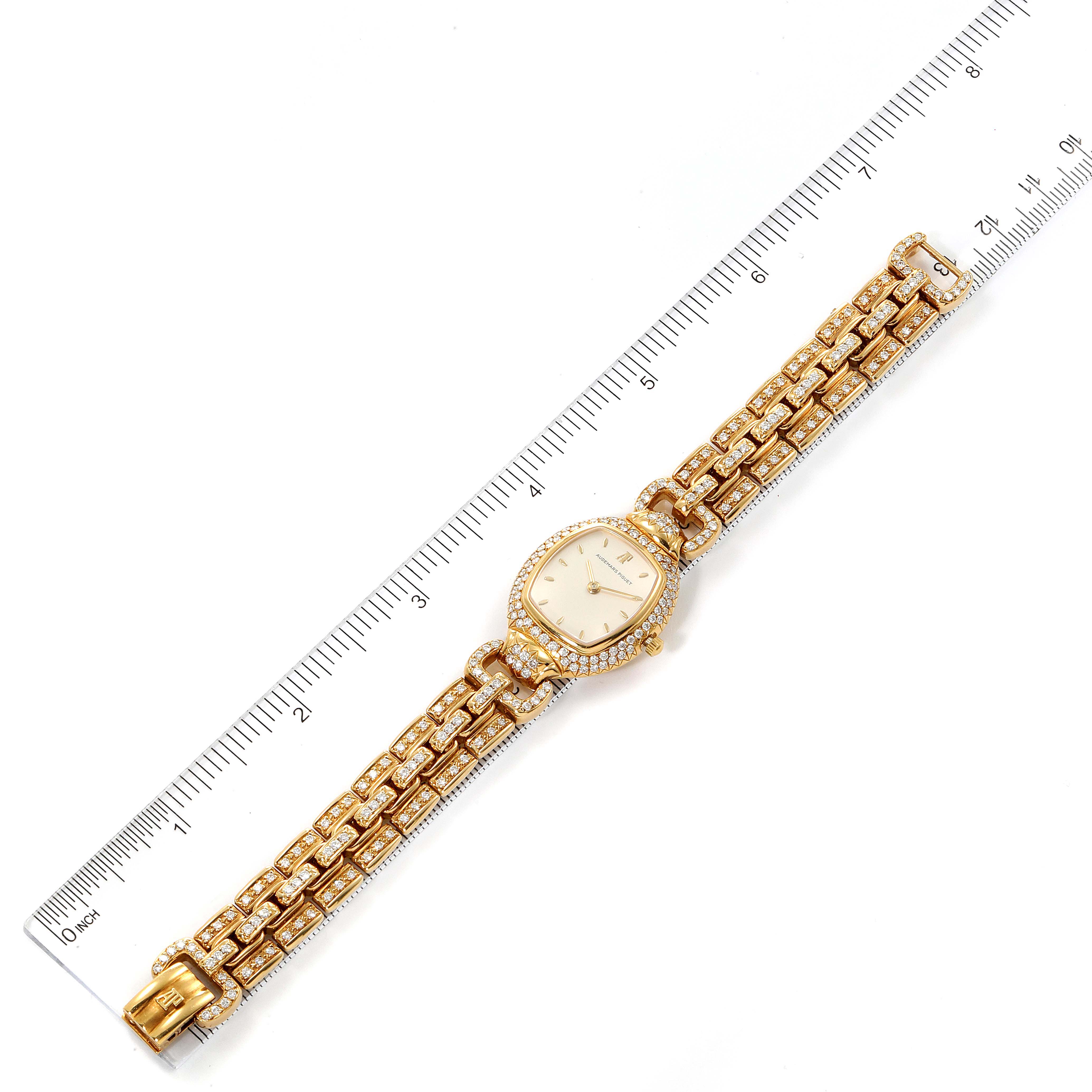 The Vintage Audemars Piguet watch is shown from an overhead angle, displaying its face, bracelet, and a surrounding ruler for scale.