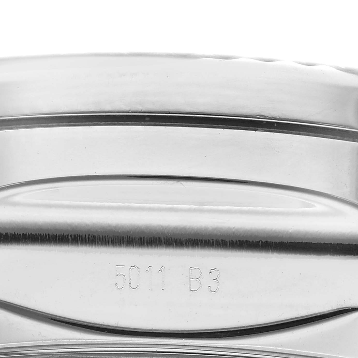 The image shows a close-up of the side detail and engraved part of a Bentley model by Breitling.