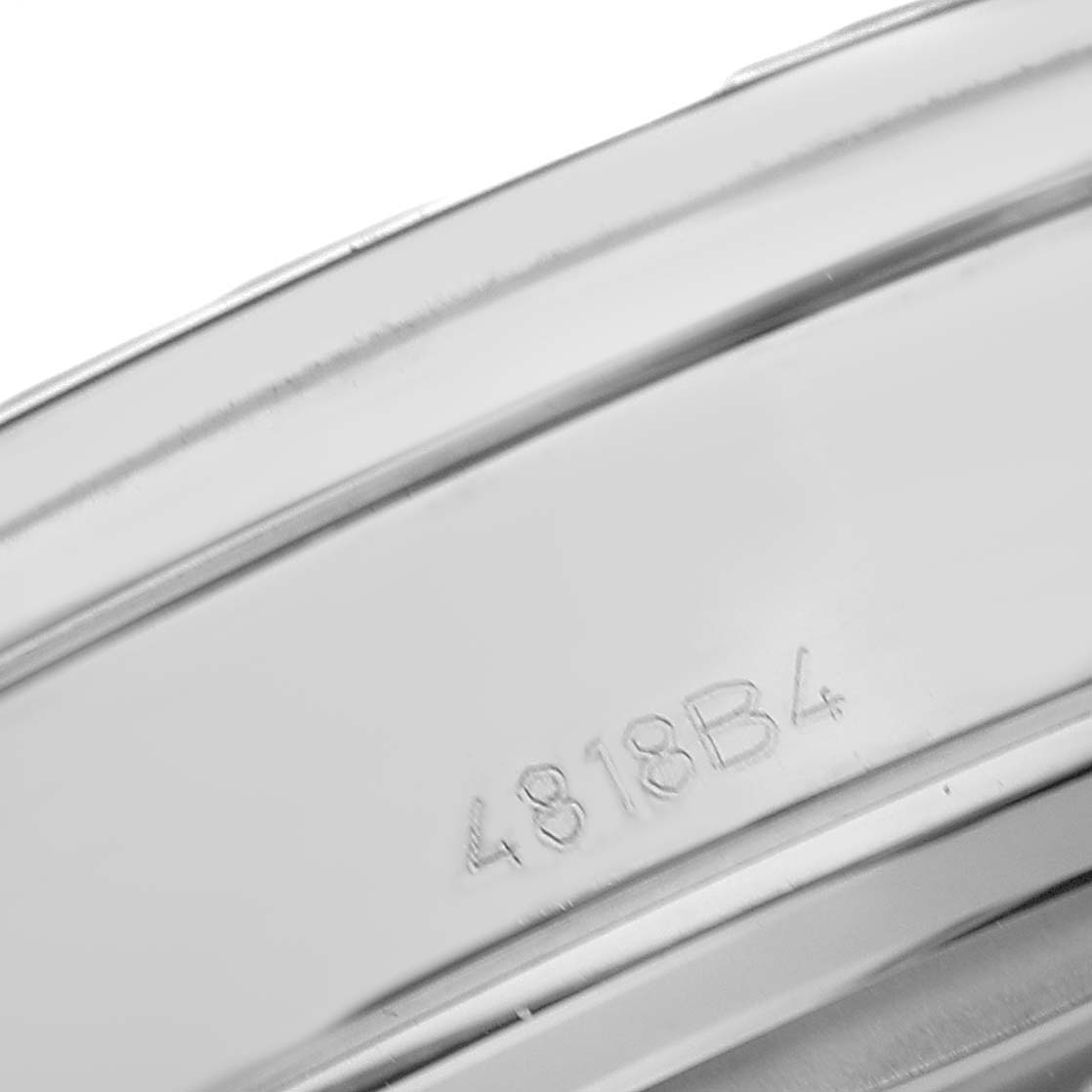 The image shows a close-up angle of the inner case or band of a Breitling Premier AB0118 Men's Stainless Steel Blue Dial watch, highlighting a serial or model number.