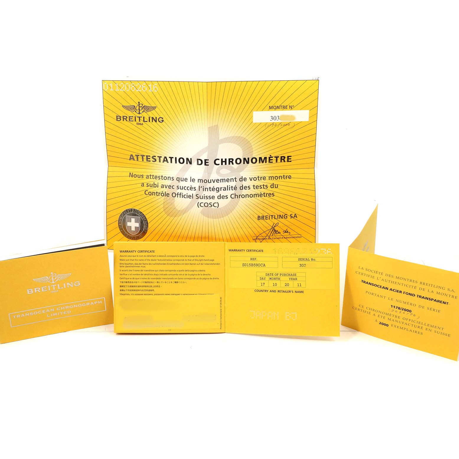 The image shows the warranty papers and chronometer certification for a Breitling Transocean AB0151 Men's Stainless Steel Black Dial watch, displayed from a front angle.