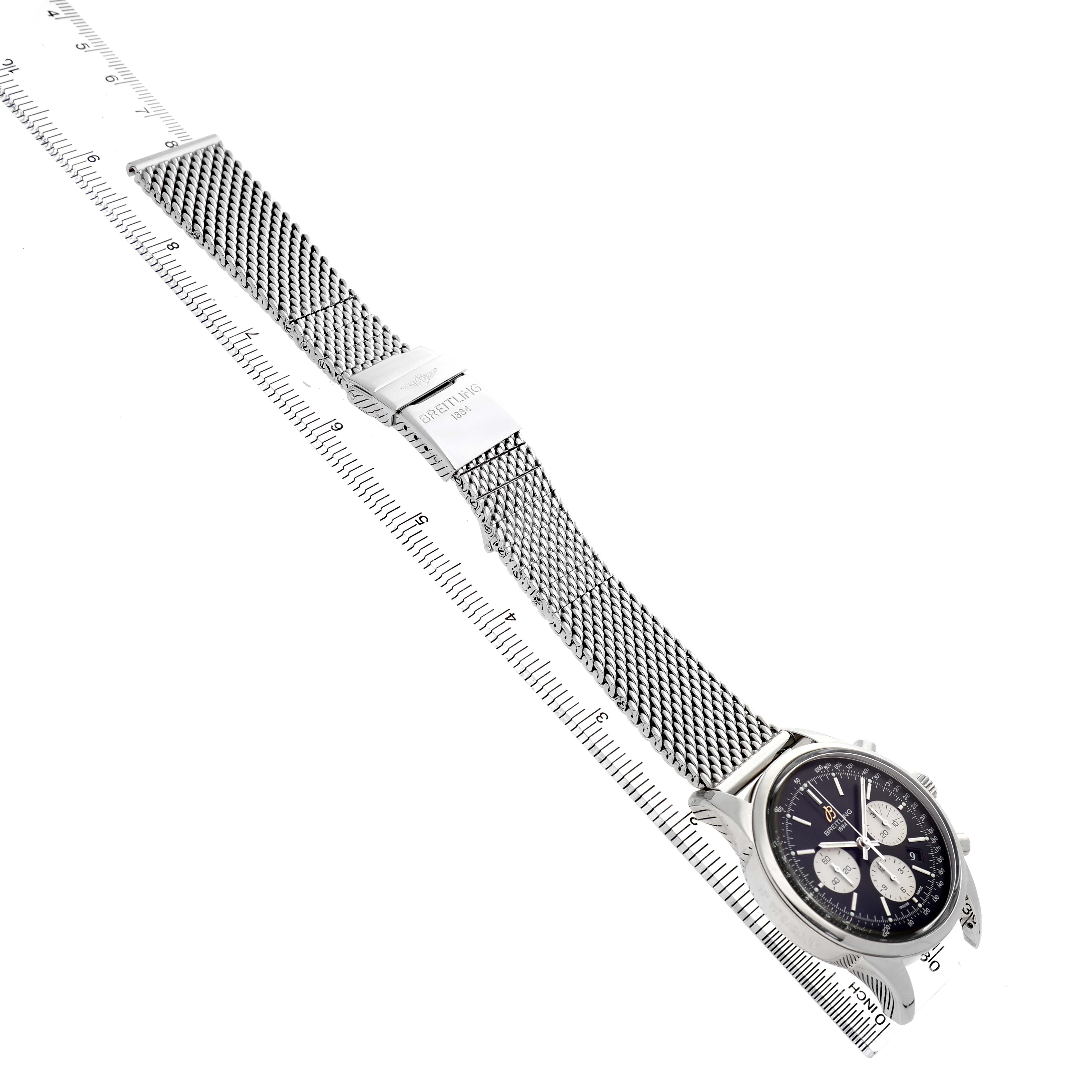 The Breitling Transocean AB0151 Men's Stainless Steel Black Dial watch is shown from an angled top view, displaying the dial, mesh strap, and clasp.