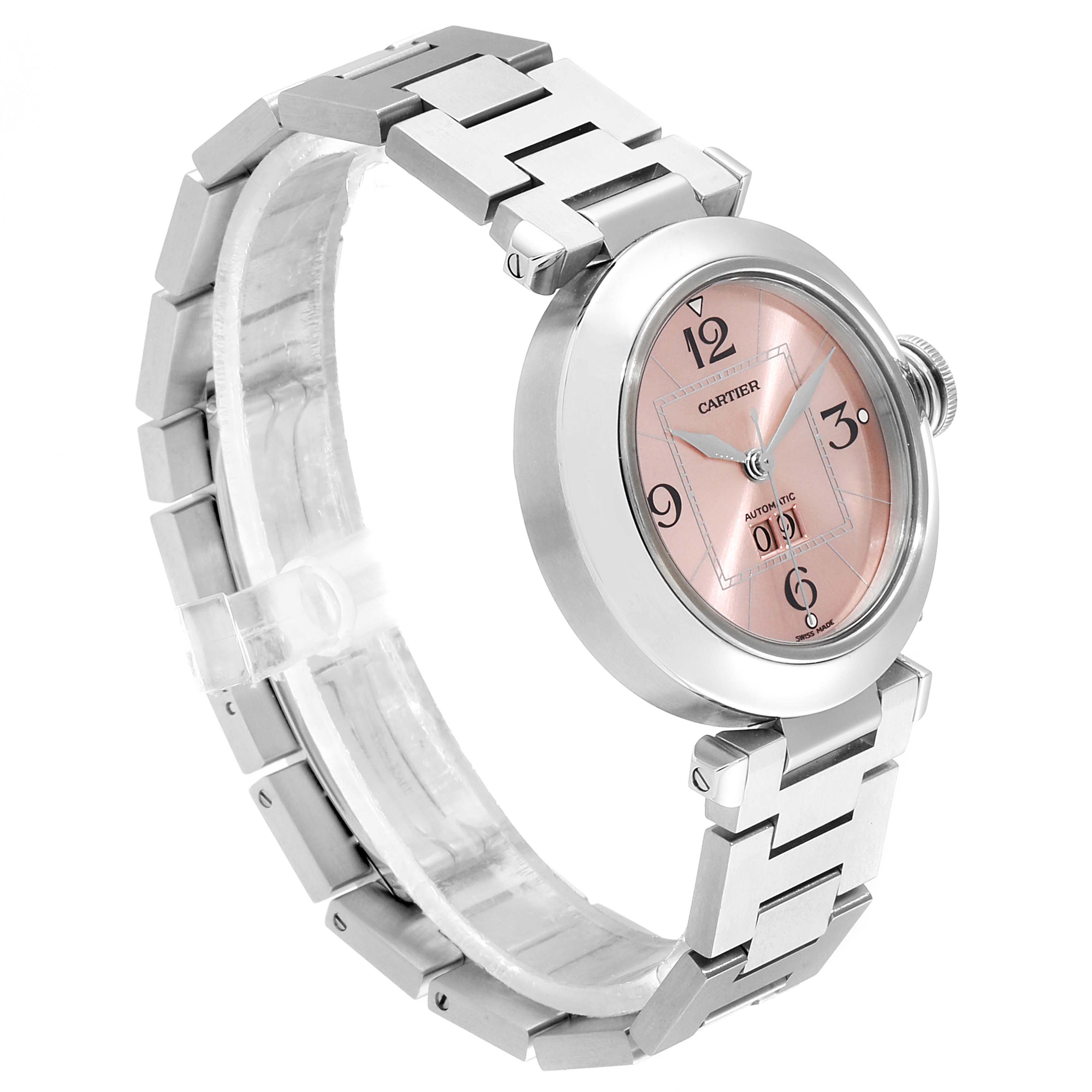 The image shows a Cartier Pasha W31058M7 Women
s Stainless Steel Pink Dial W31058M7 Women
s Stainless Steel Pink Dial watch from a slight side angle, highlighting its pink dial and metallic bracelet.