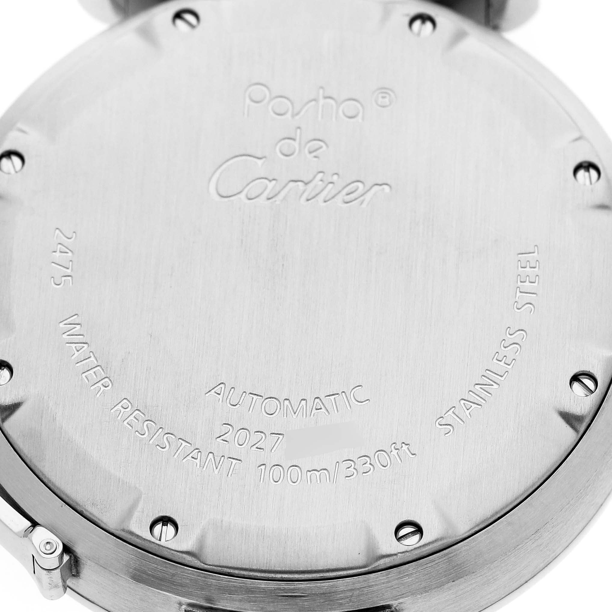 The image shows the back case of a Cartier Pasha W31055M7 Men's Stainless Steel White Dial watch, highlighting engraved details and screws.