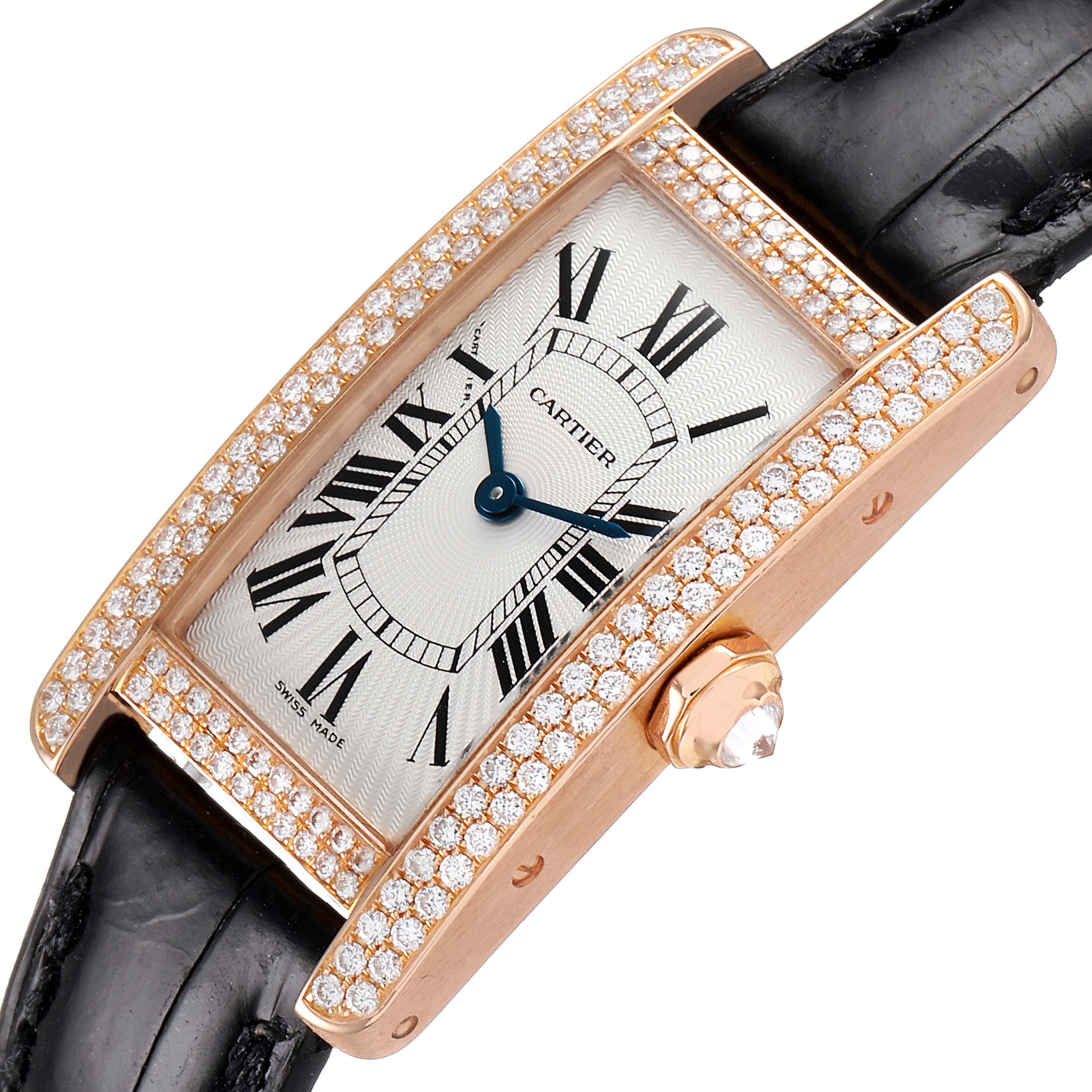 The Cartier Tank Americaine WJTA0002 Women
s Rose Gold Silver Dial WJTA0002 Women
s Rose Gold Silver Dial watch is shown at a tilted angle, displaying its diamond-encrusted bezel, leather strap, and crown with a diamond tip.