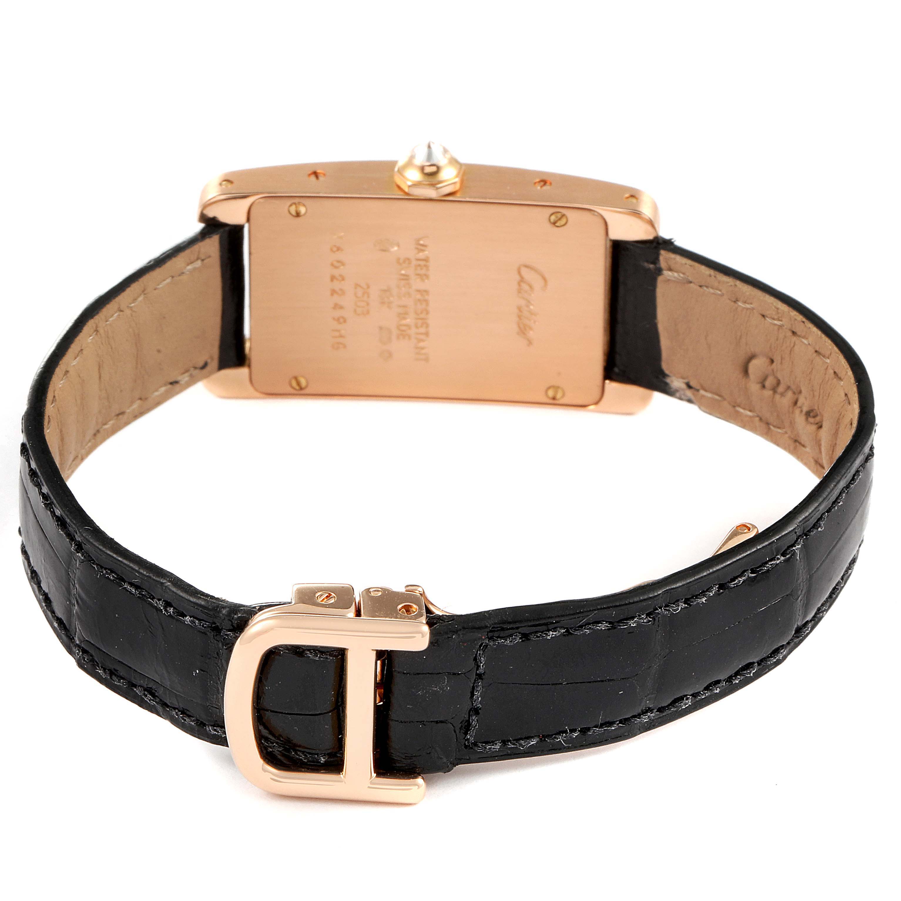 This image shows the back and clasp of a Cartier Tank Americaine WJTA0002 Women
s Rose Gold Silver Dial WJTA0002 Women
s Rose Gold Silver Dial watch, highlighting its gold case and black leather strap.