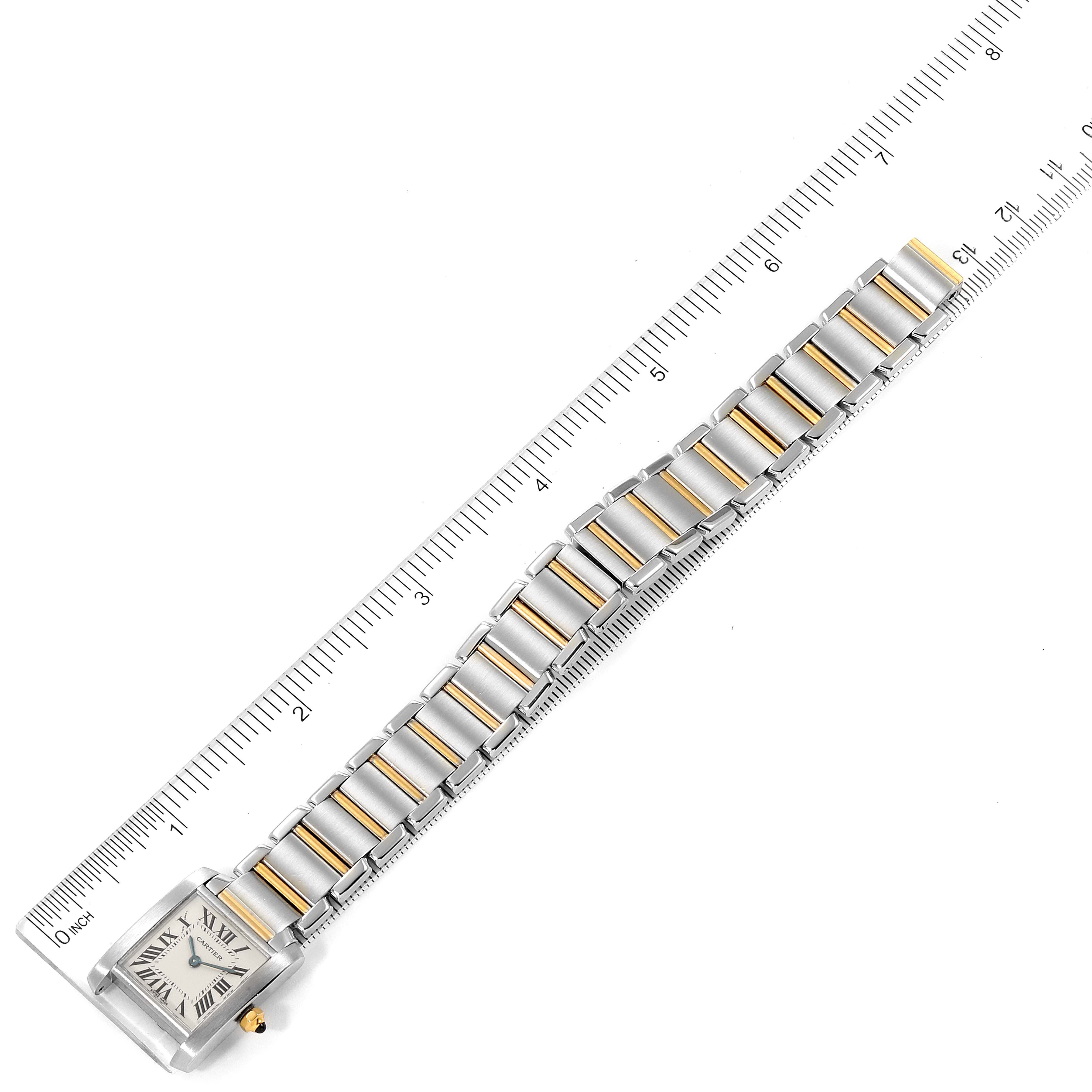 The image shows the Cartier Tank Francaise W51007Q4 Women's Steel and Gold (two tone) Silver Dial W51007Q4 Women's Steel and Gold (two tone) Silver Dial watch laid flat with a ruler measuring its length, displaying the face and bracelet.