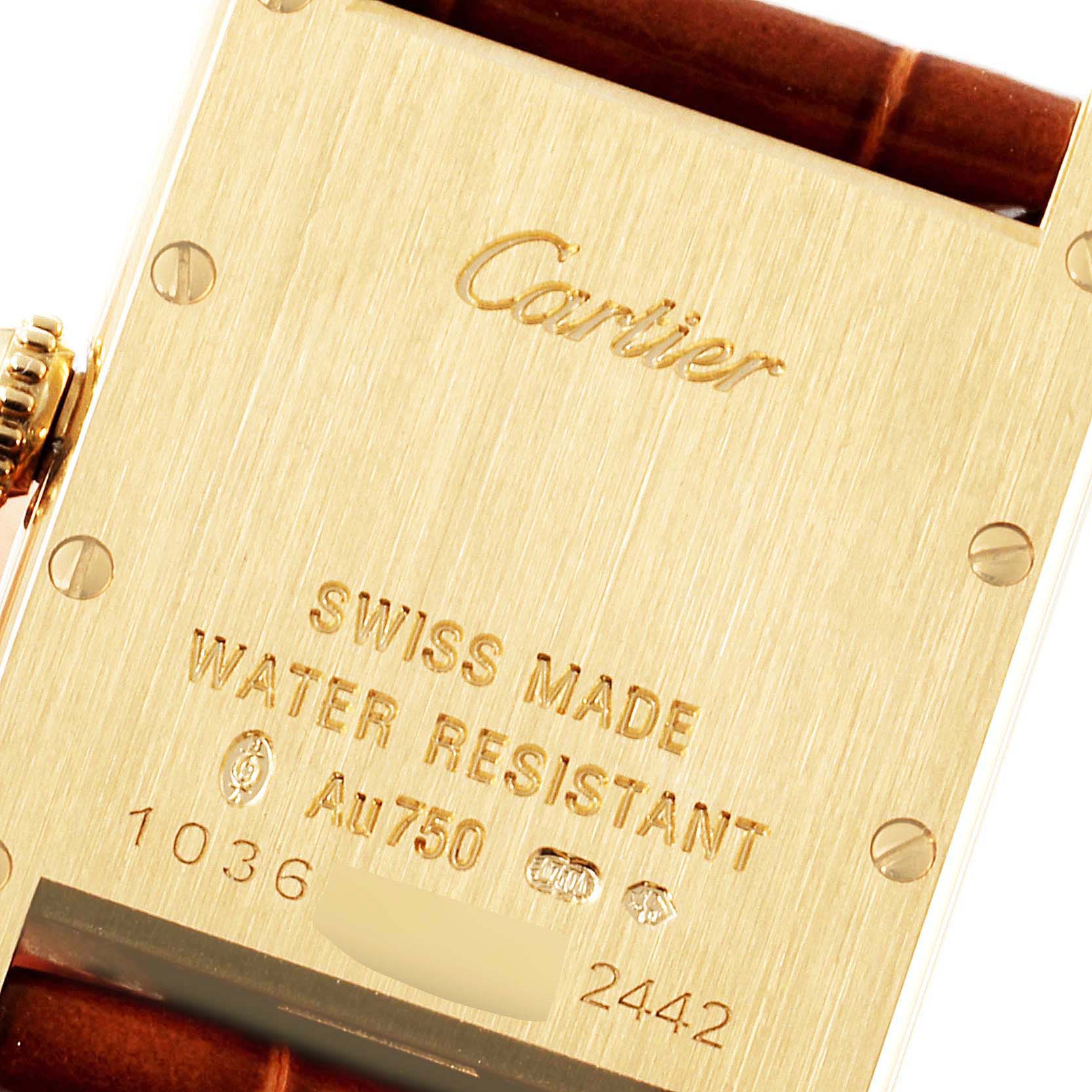 This image shows the back case of the Tank Louis watch by Cartier, highlighting its engraving and part of the leather strap.