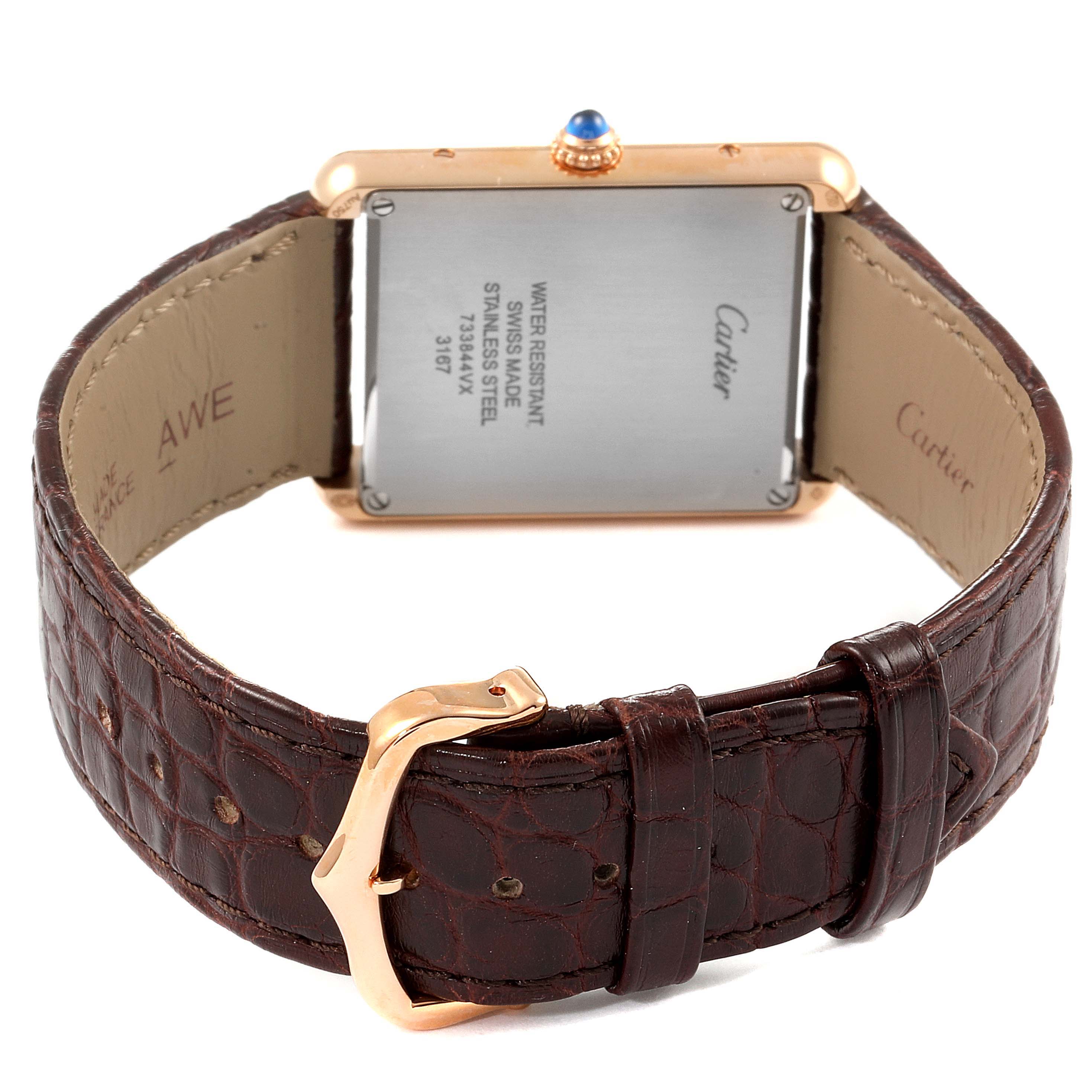 The Cartier Tank Solo W5200025 Men
s Rose Gold Silver Dial W5200025 Men
s Rose Gold Silver Dial watch is shown from the back, displaying its leather strap, buckle, and case back.