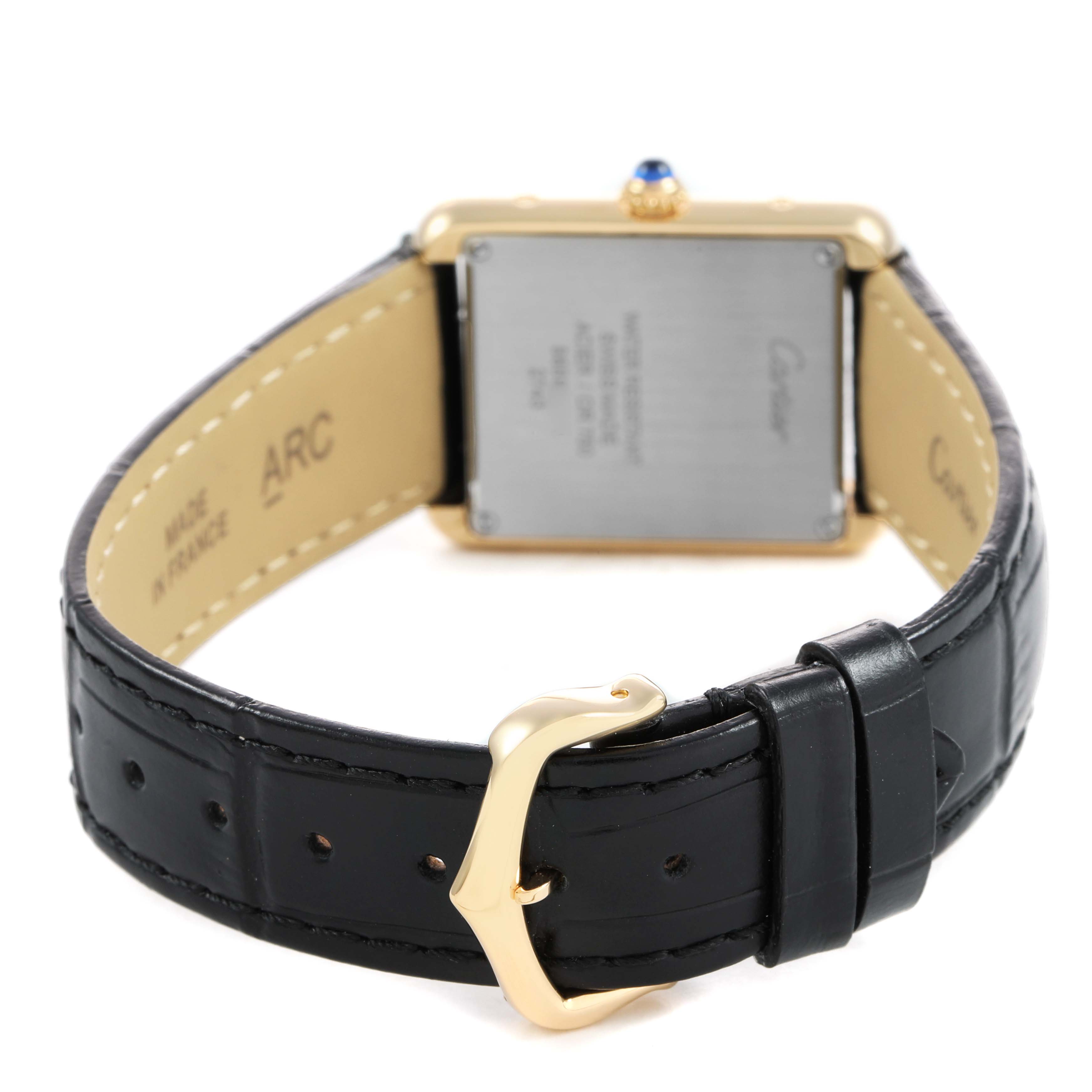 The image shows the back and strap of a Cartier Tank Solo W1018755 Women's Yellow Gold Silver Dial watch at an angle, highlighting the buckle and caseback.