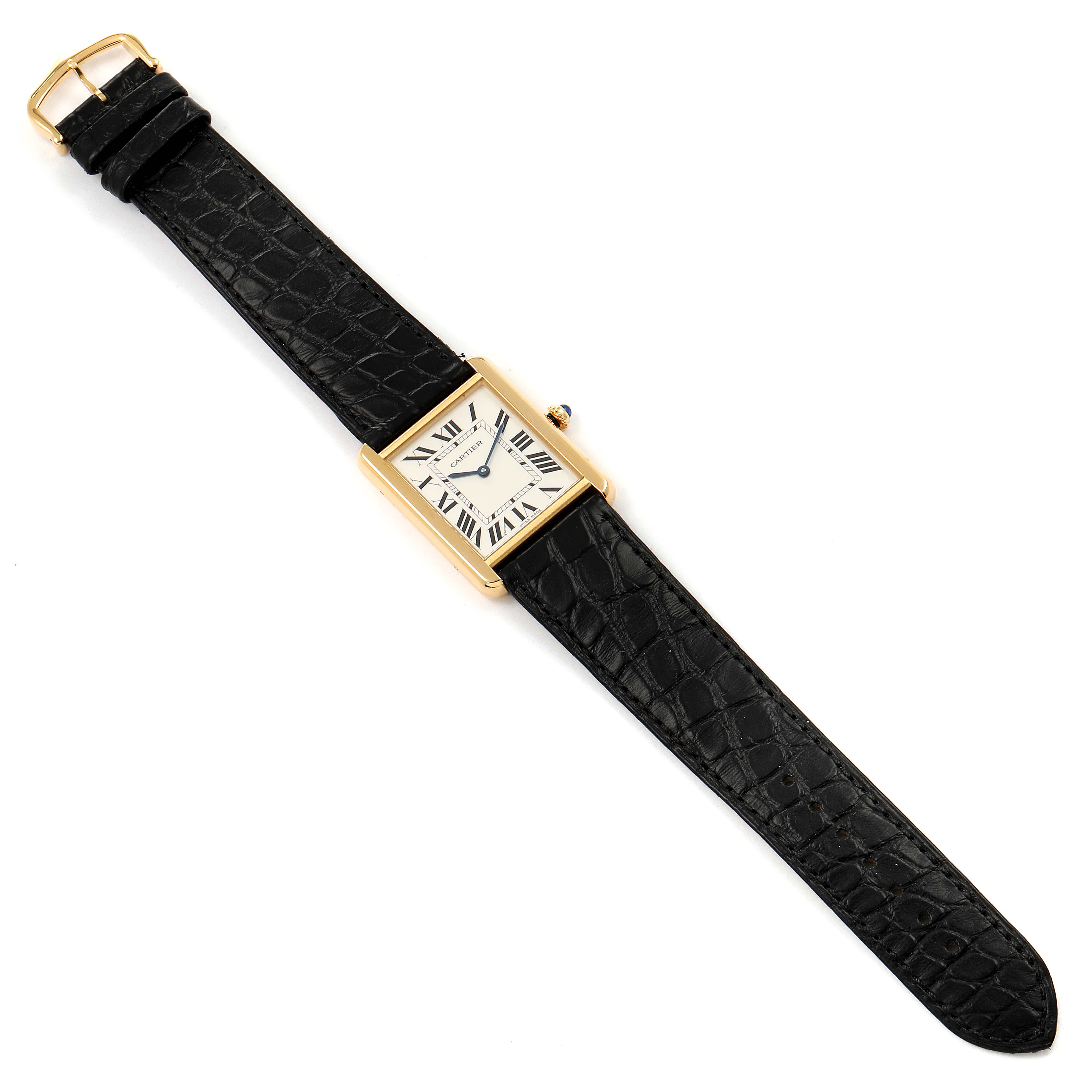 The Cartier Tank Solo W5200004 Men's Yellow Gold Silver Dial W5200004 Men's Yellow Gold Silver Dial watch is shown from a top-down angle, displaying its face, black strap, and gold casing.